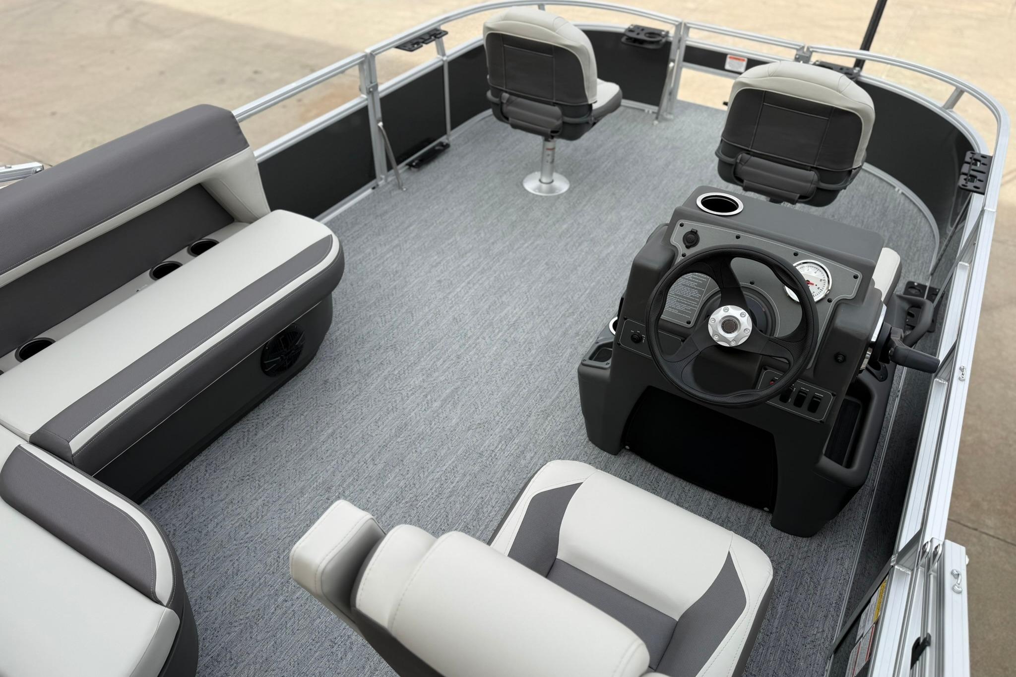 2026 Sun Tracker Bass Buggy 16 XL Select pontoon boat interior with seating and steering console.