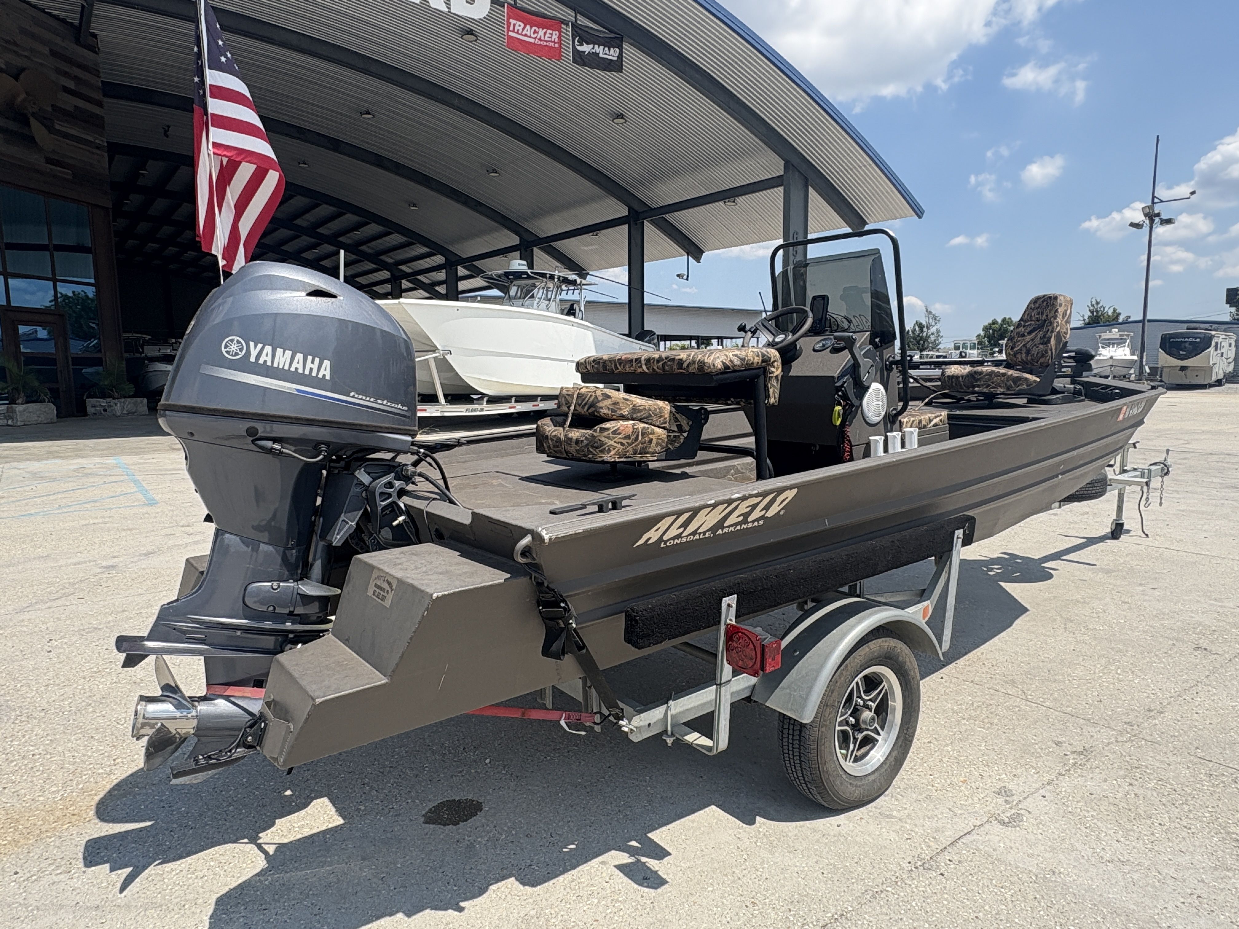 2023 Alweld 16x52 Marsh boat with Yamaha motor on trailer, displayed outdoors.