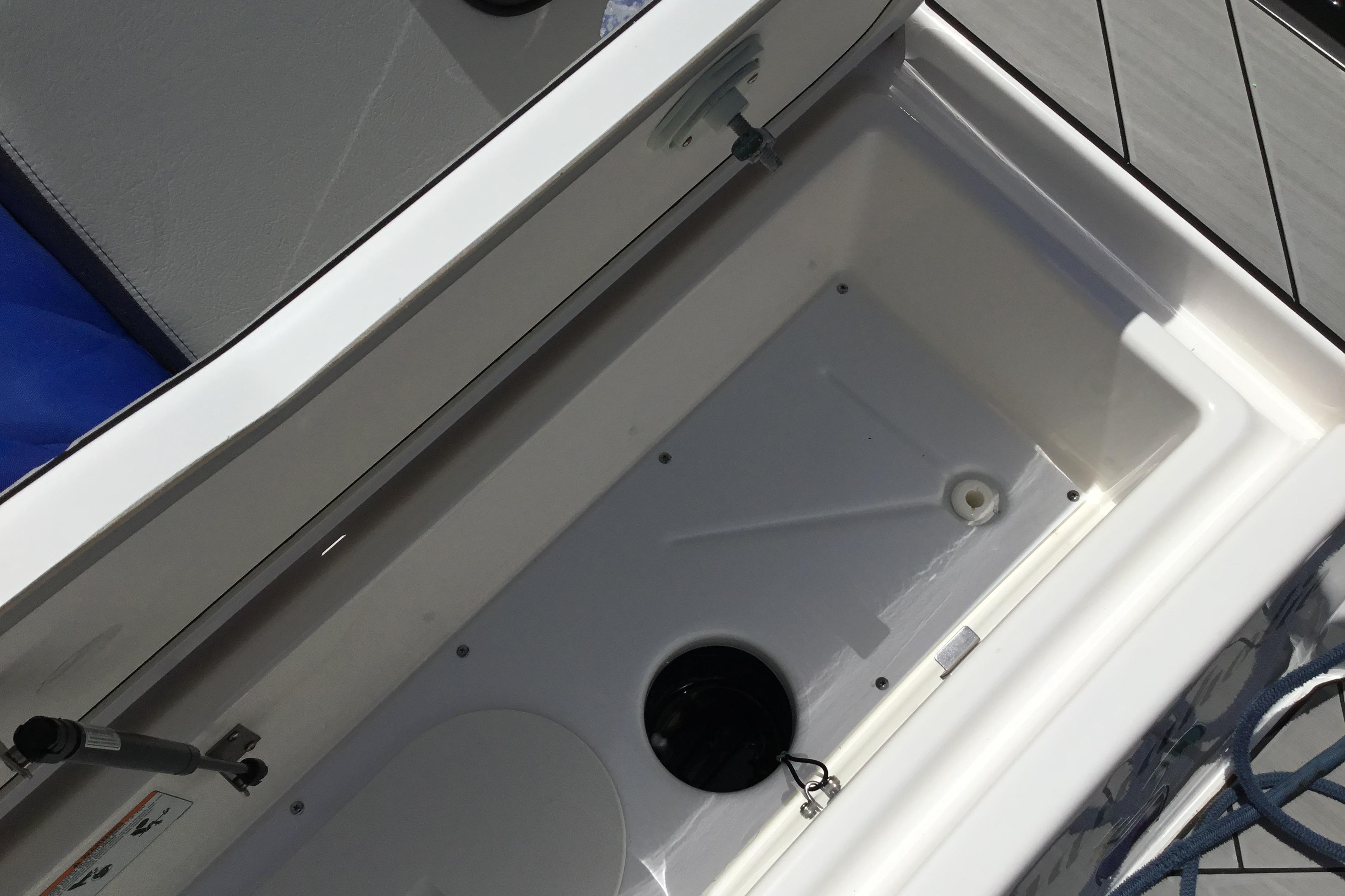 Storage compartment of 2023 Yamaha Boats 252XE, featuring a spacious interior design.