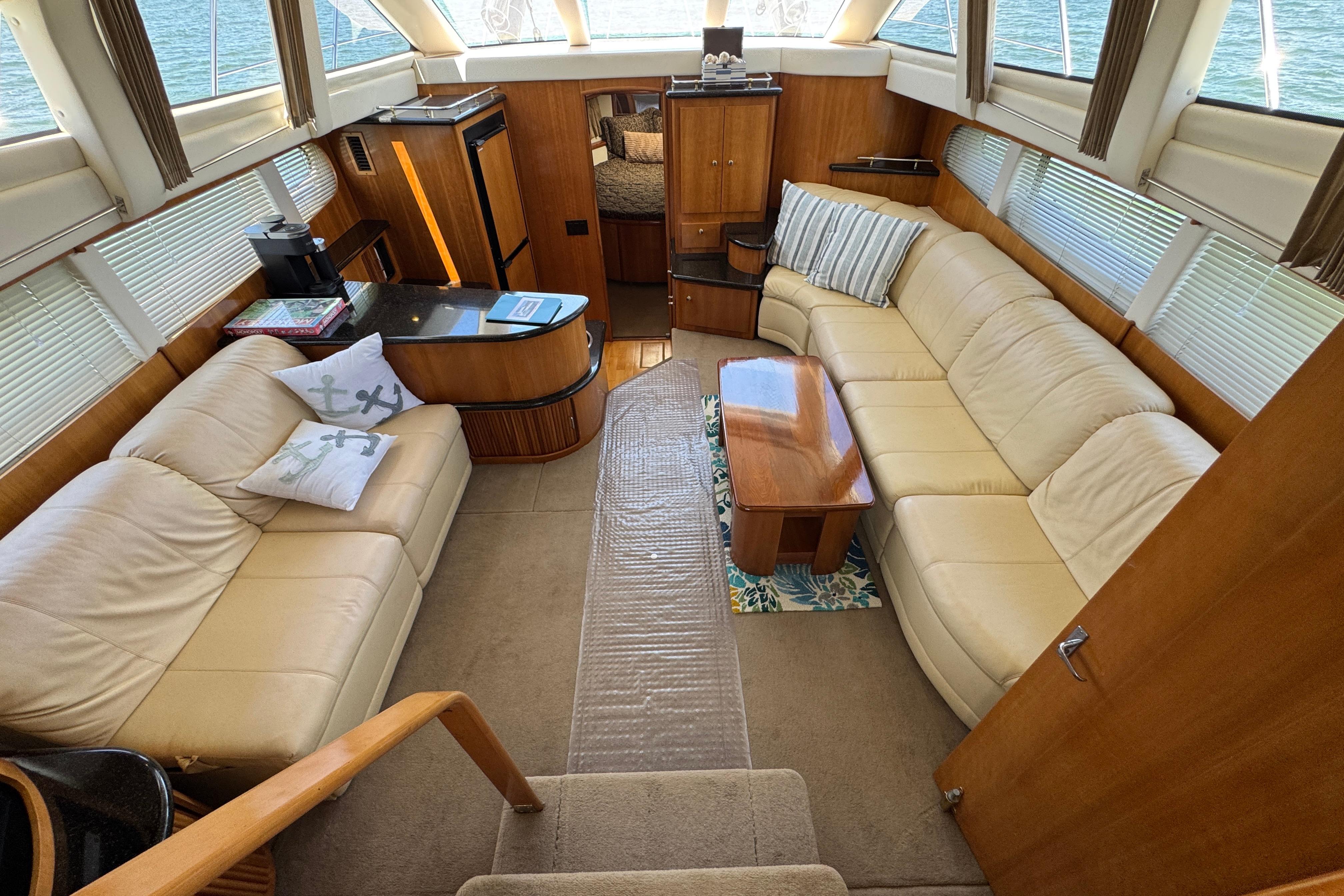 Luxurious interior of 2002 Carver 396 Motor Yacht with plush seating and elegant wood finishes.