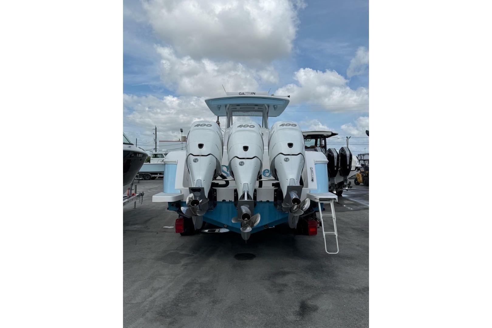2020 Intrepid 375 Nomad SE with triple 400 horsepower engines, docked under a cloudy sky.