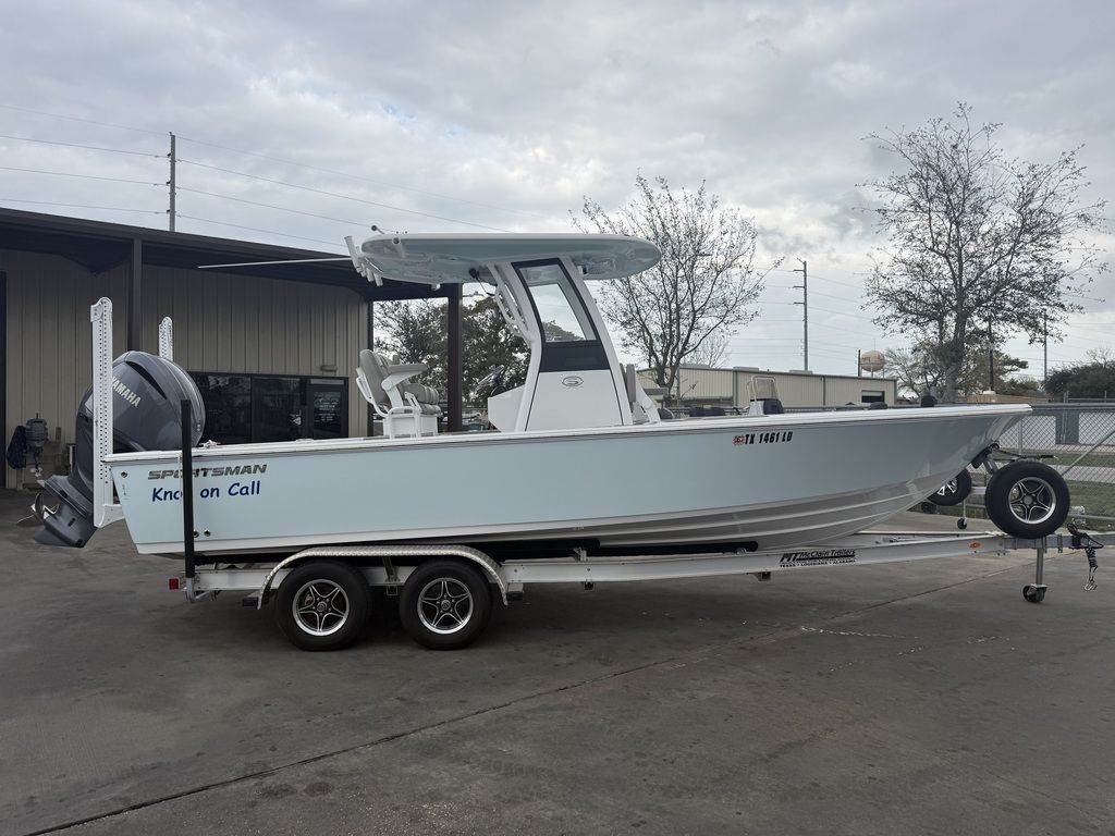 A 2025 Sportsman Masters 247OE Bay Boat on a trailer in a yard.