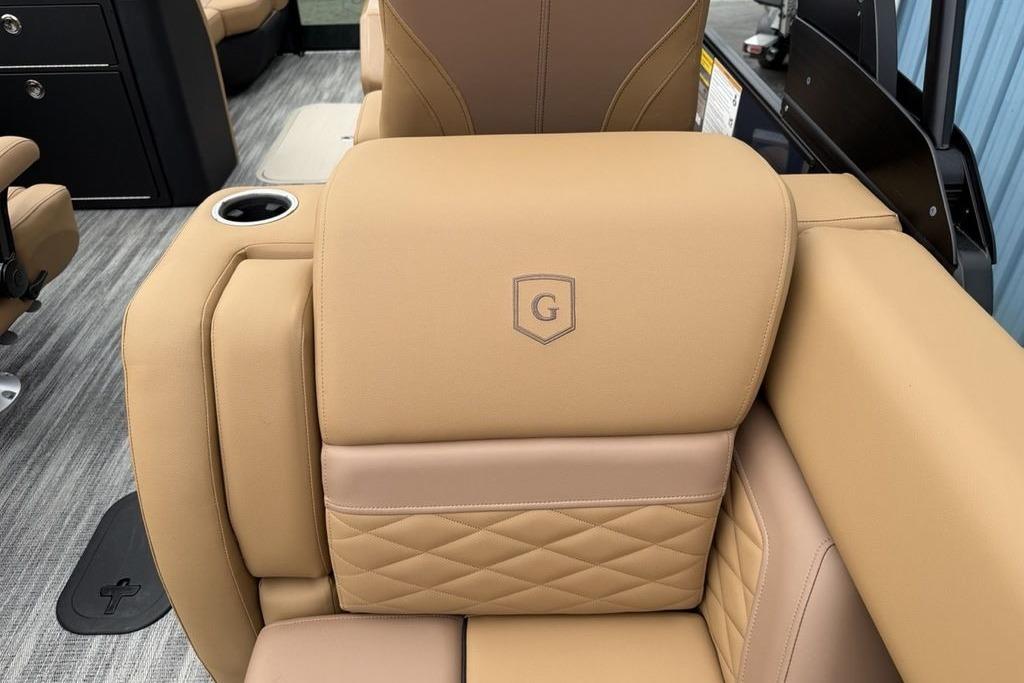 Luxurious tan seating on 2026 Godfrey Monaco 235 SFLC iMPACT boat, featuring quilted design and cup holder.