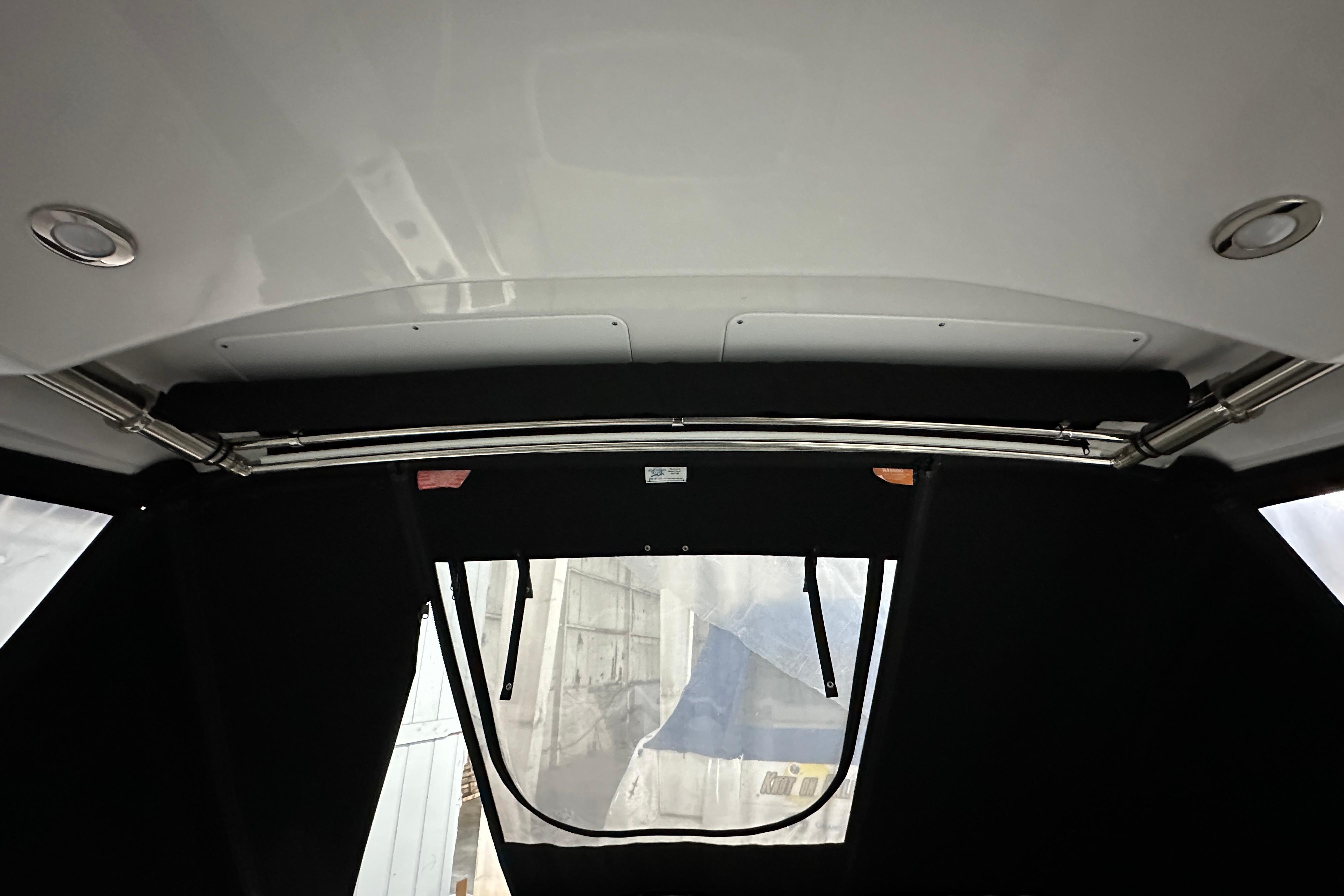 Interior view of 2023 Monterey 378SS Super Sport boat with canopy and metal framework.
