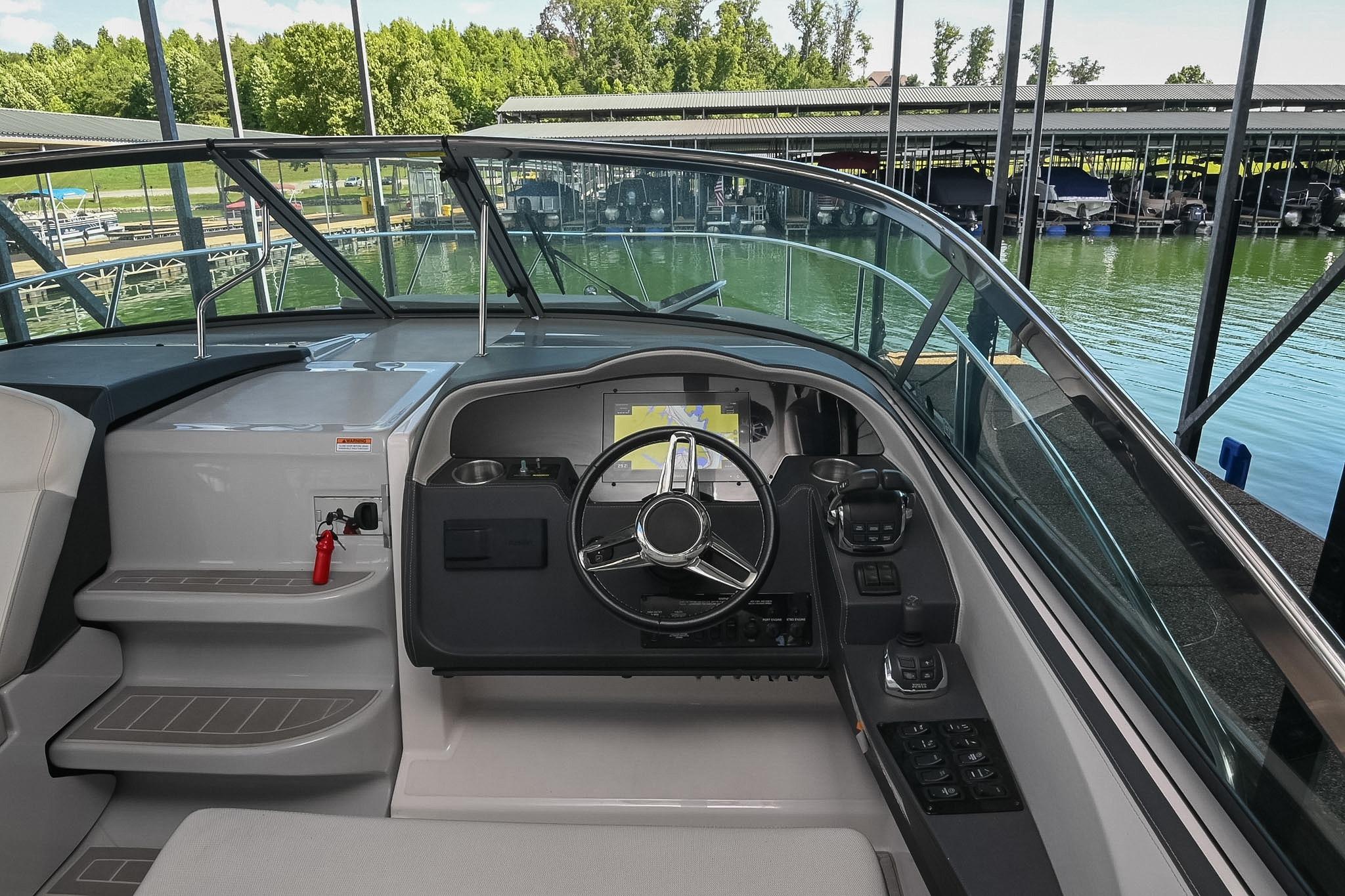 2021 Regal 33 Express boat cockpit with modern steering and navigation controls.