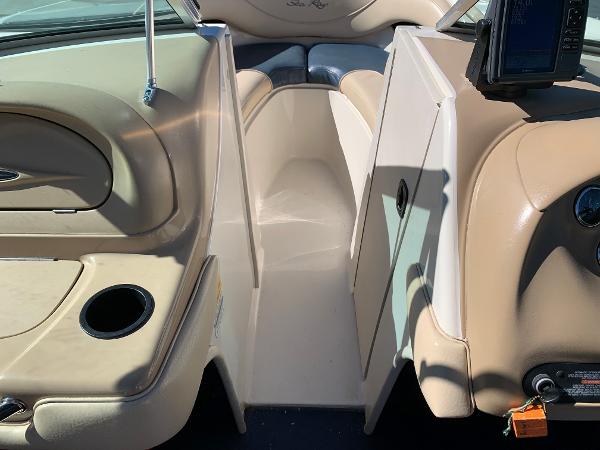 Interior of a 2000 Sea Ray 210 Bow Rider boat showing seating and console.