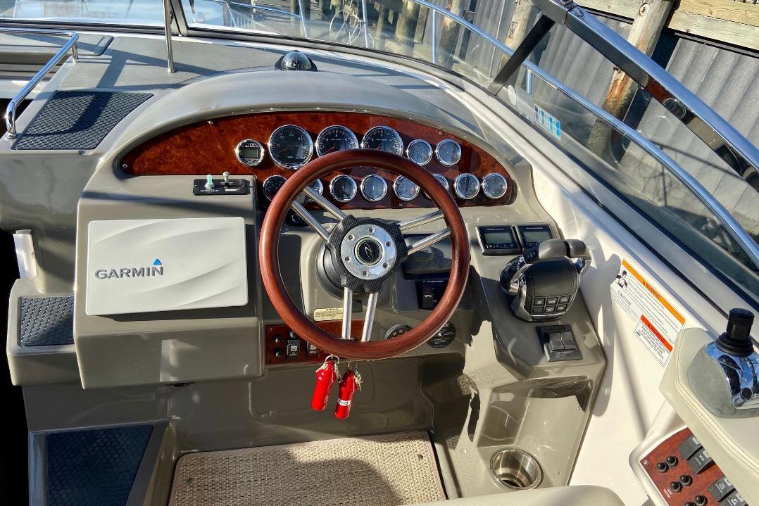 2012 Regal 35 Express Cruiser helm with Garmin navigation and wood-accented steering wheel.