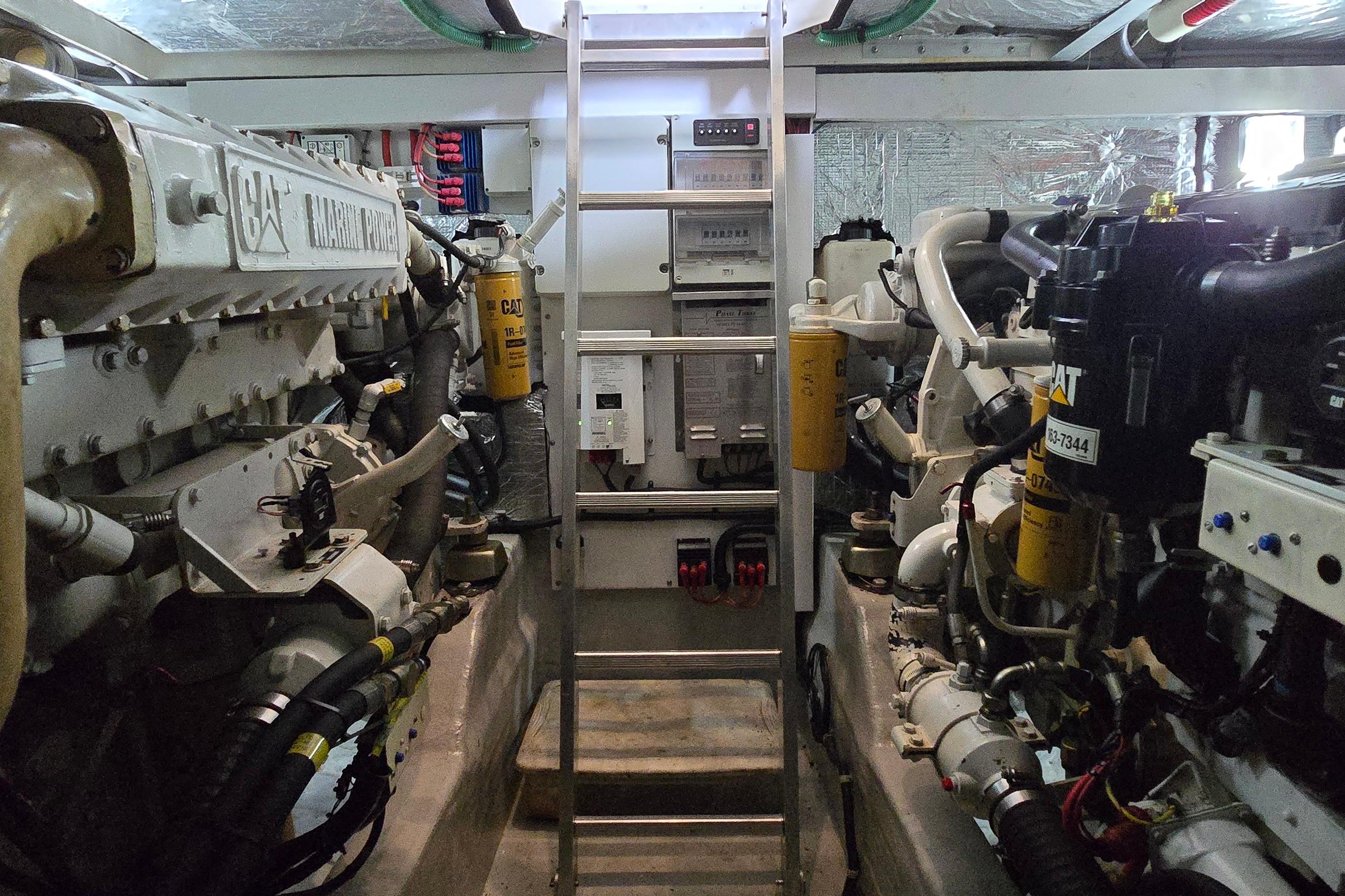 Engine room of a 2004 Sunseeker Camargue 50 yacht, featuring Caterpillar marine engines.
