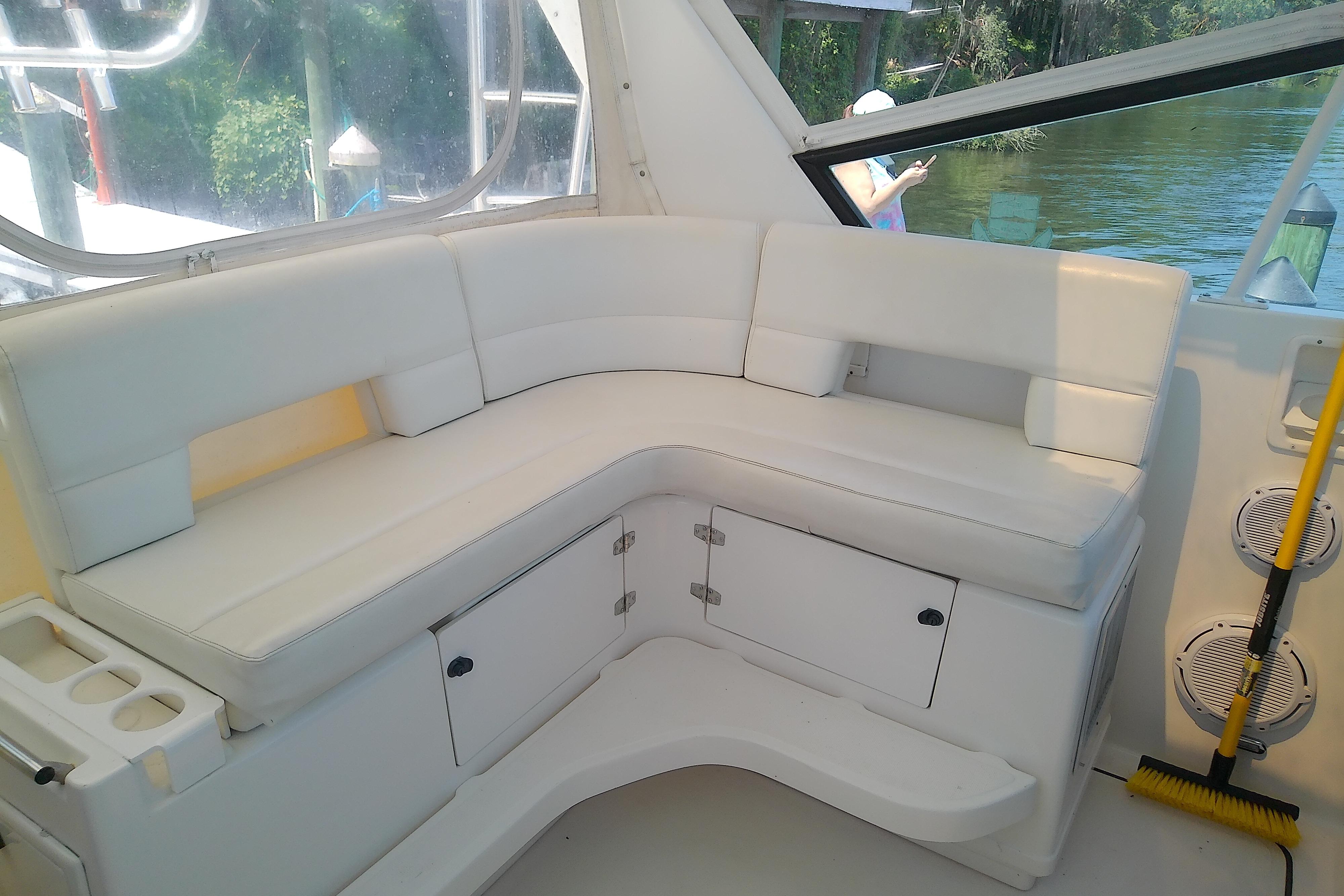 White seating area on a 2000 Tiara Yachts 4100 Open boat, with storage compartments.