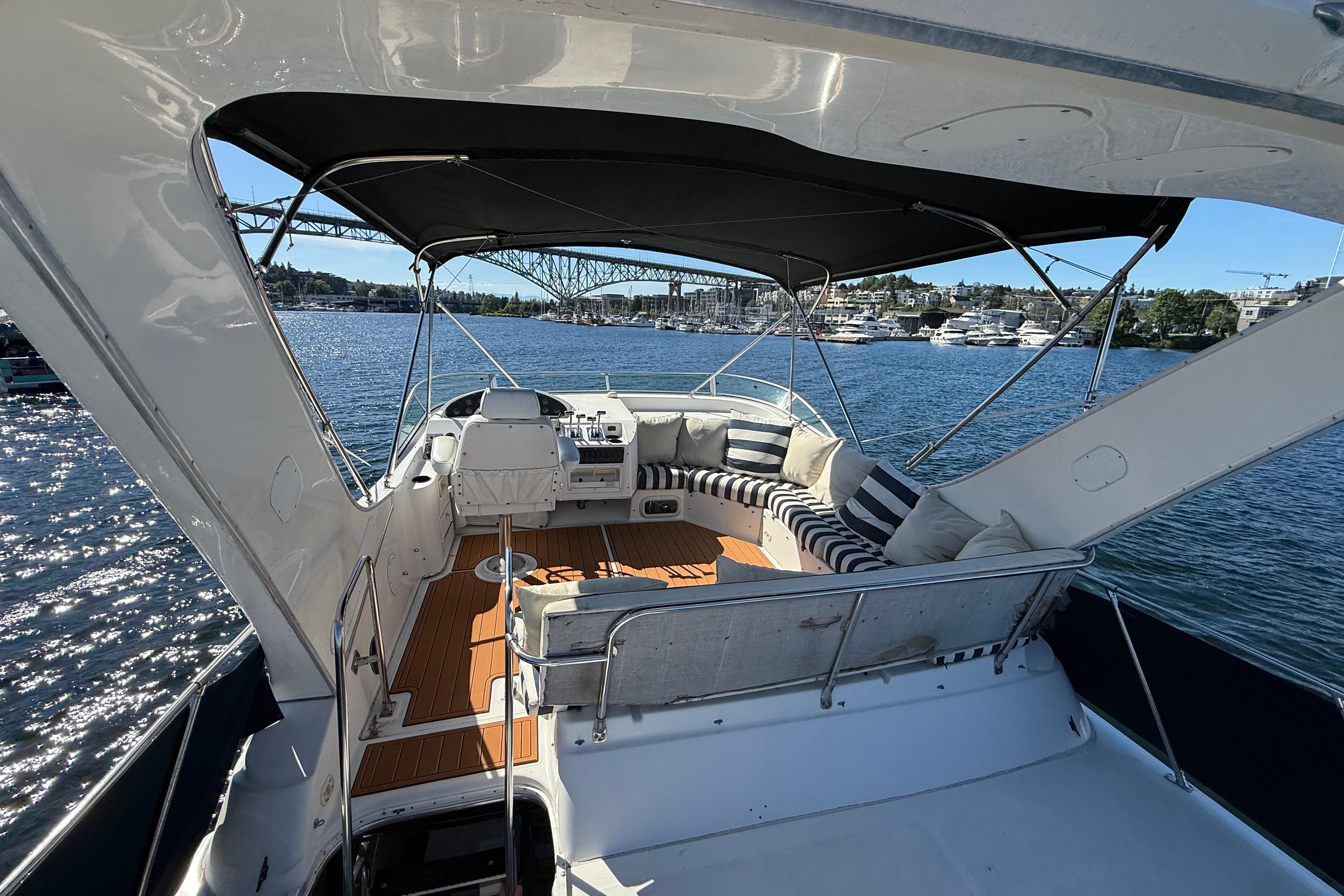 1997 Bayliner 3988 Command Bridge Motoryacht with spacious deck and scenic waterfront view.