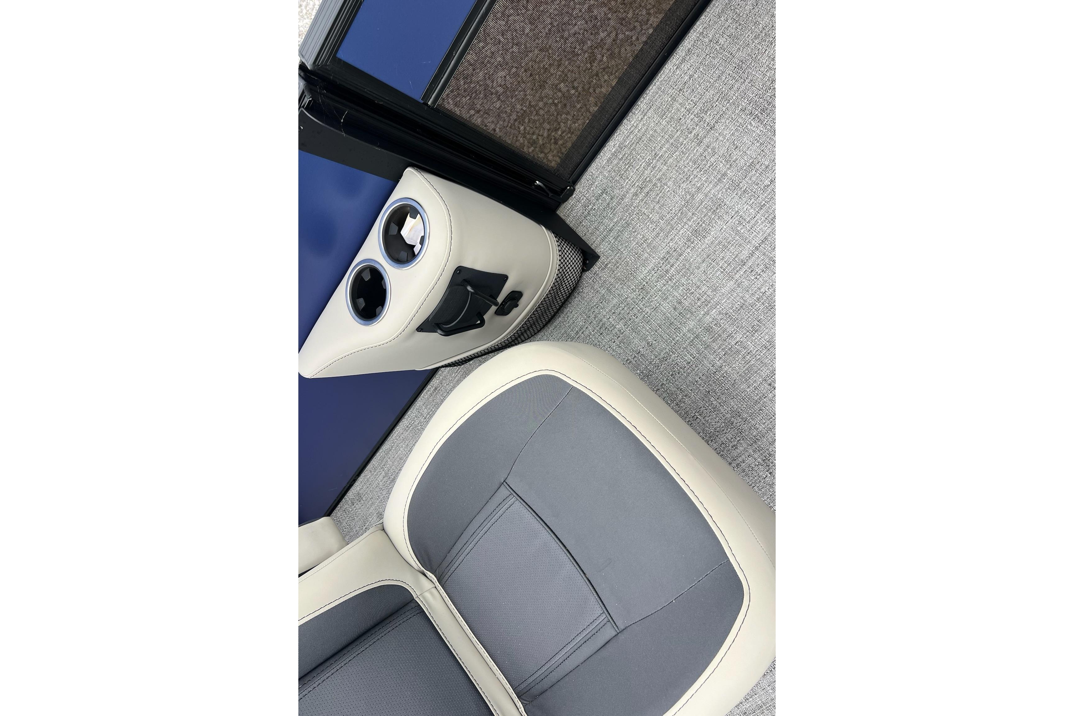 2023 Barletta C22 boat interior with gray and beige seating, cup holders, and carpeted flooring.
