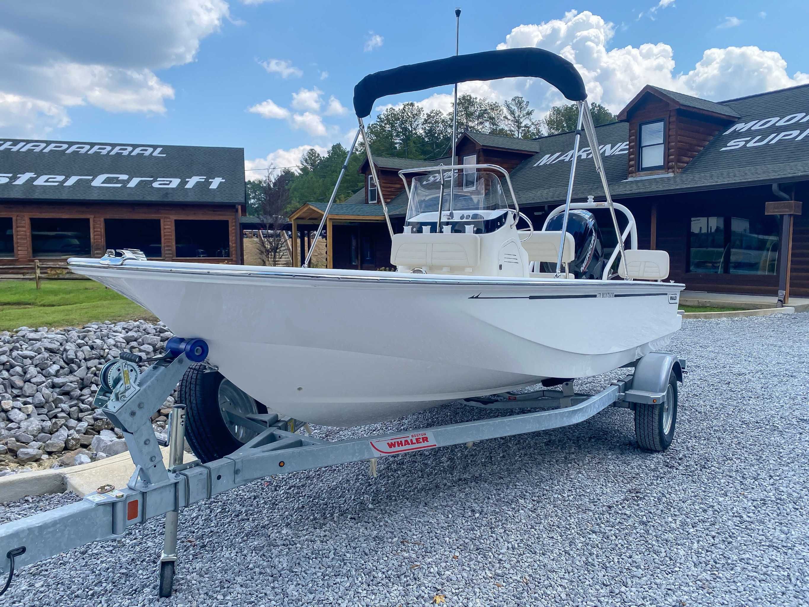 2025 Boston Whaler 170 Montauk on trailer in front of a store.