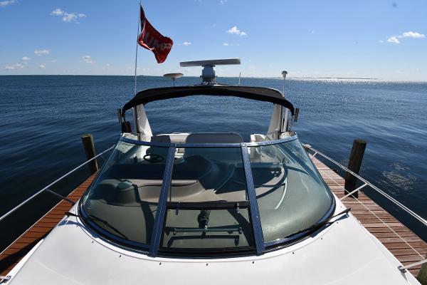 1997 Sea Ray 400 Sundancer docked, with clear skies and calm waters in the background.