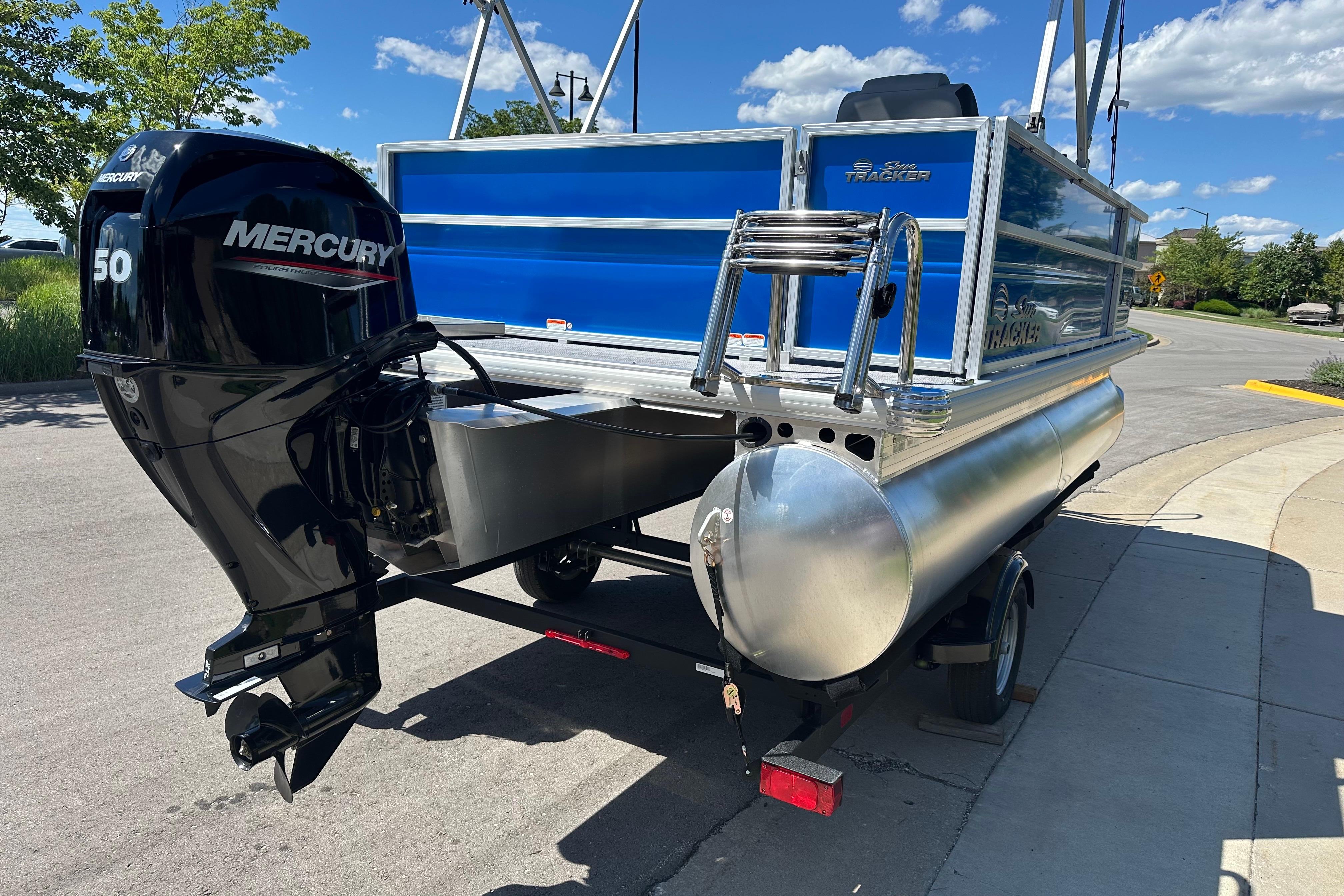 2026 Sun Tracker Party Barge 16 DLX with Mercury 50 engine on a trailer.