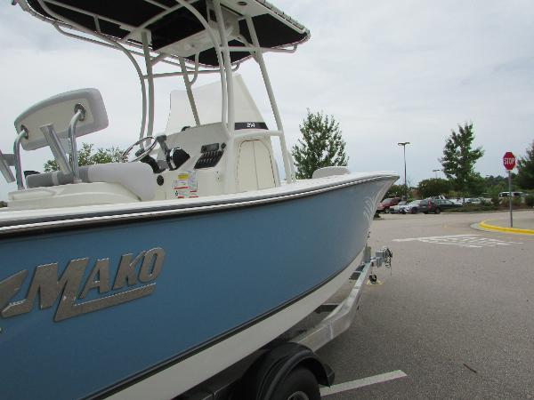 2023 Mako 214 CC boat in a parking lot.