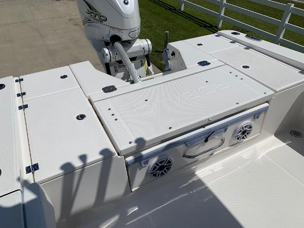 2024 Robalo 266 Cayman boat deck with storage compartments and motor.