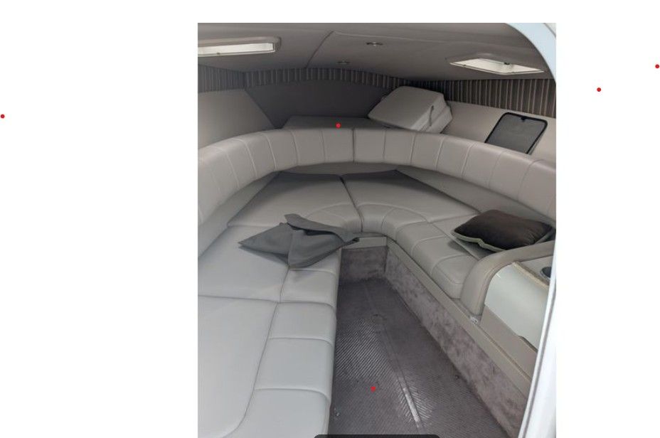 Interior of the 2003 Formula 260 Sun Sport with cushioned seating and pillows.