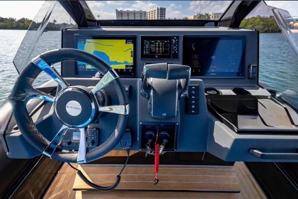 Cockpit of 2025 Technohull 38 Gran with advanced navigation displays and steering wheel.