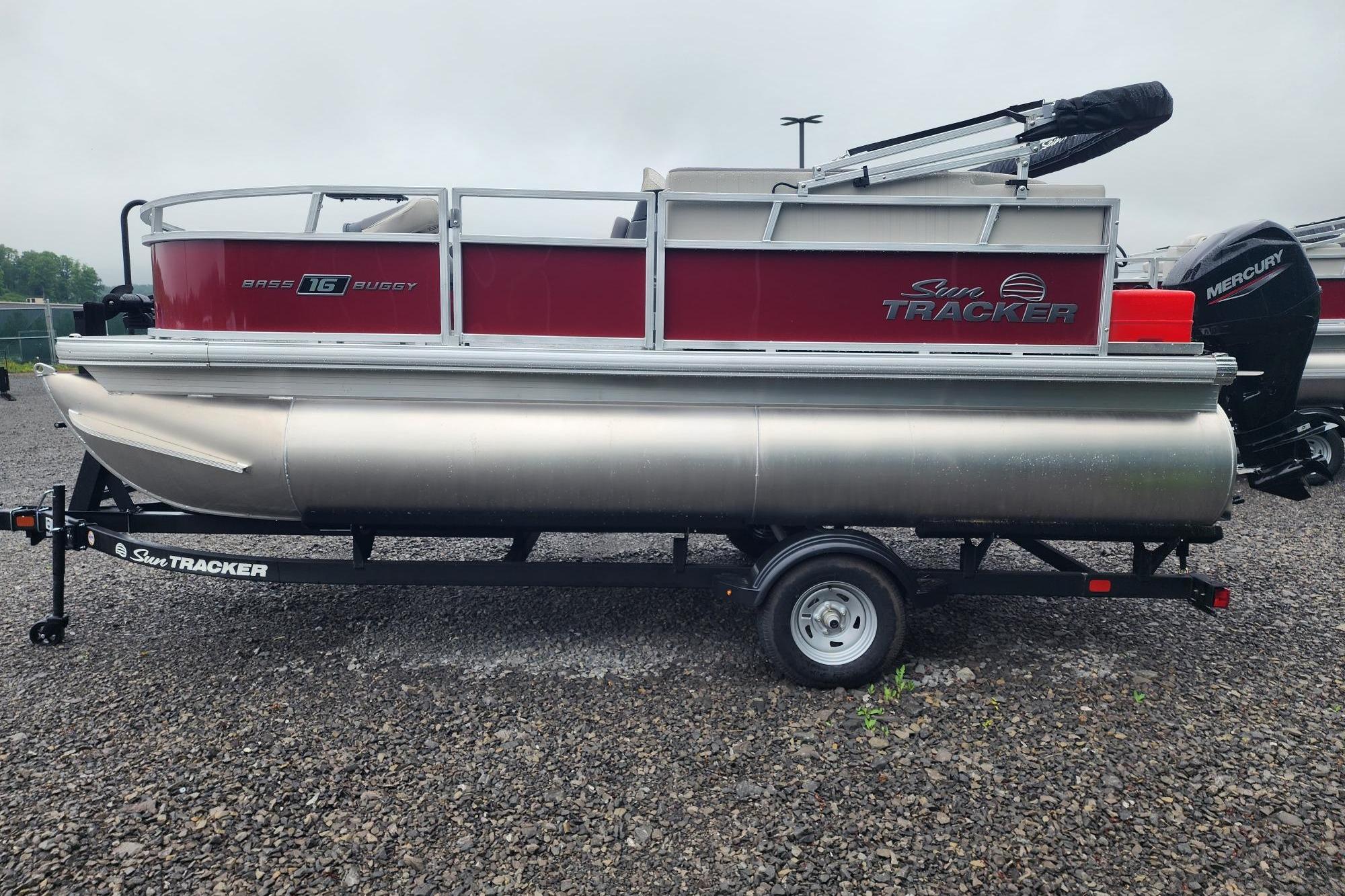 2026 Sun Tracker Bass Buggy 16 XL Select pontoon boat on trailer, side view.