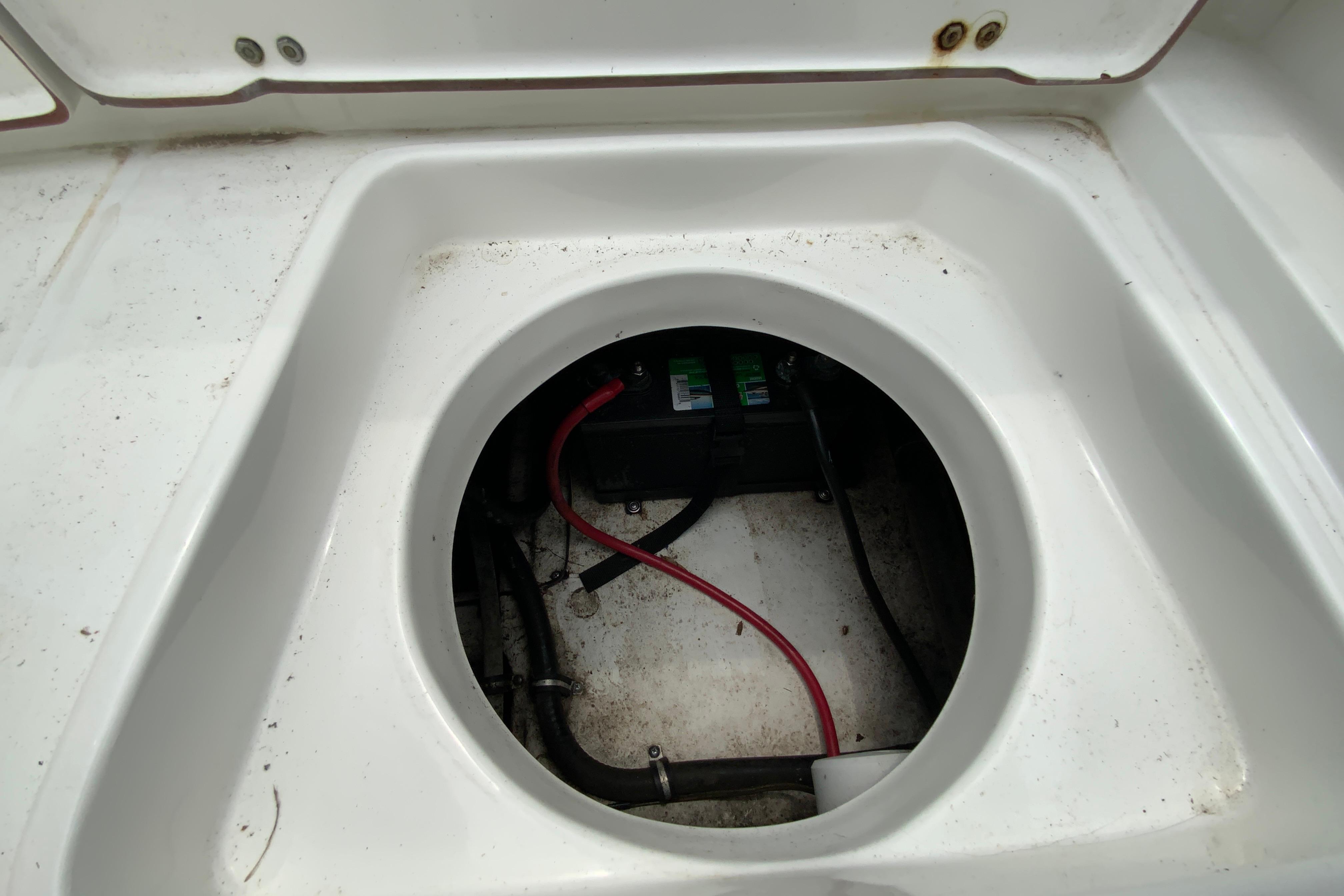 2014 Sea Hunt Escape 211 LE boat battery compartment with visible wiring.