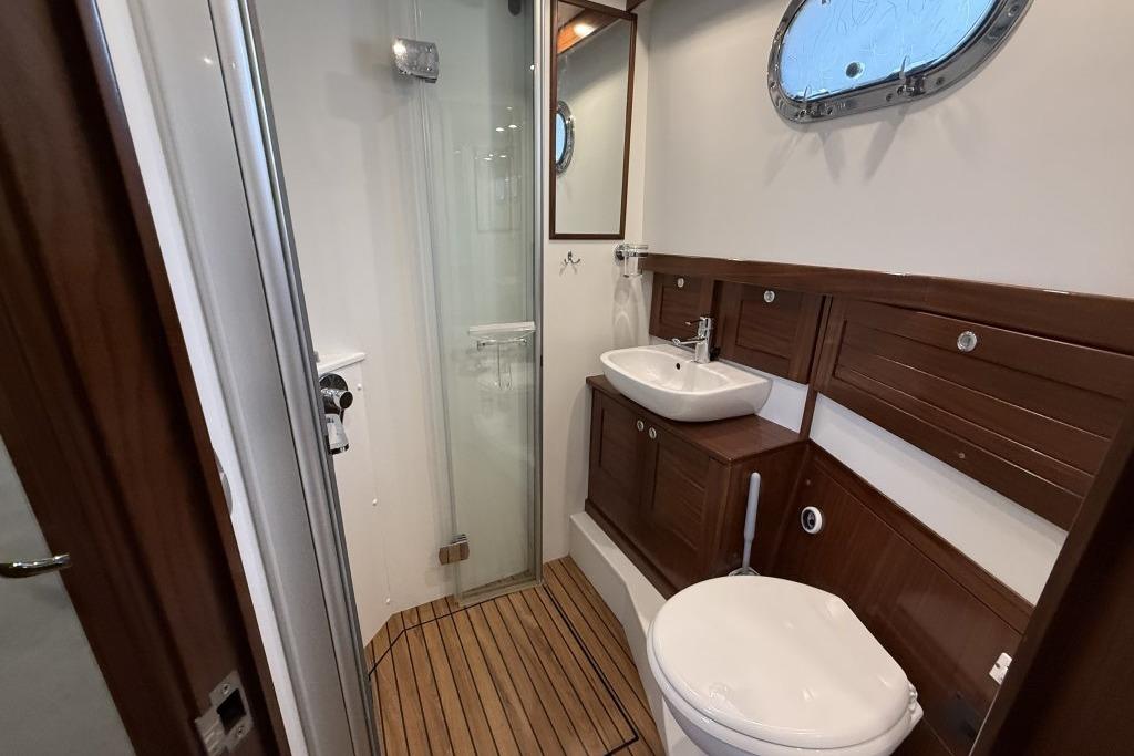 Luxurious bathroom in 2012 Sasga Yachts Menorquin 42, featuring wood accents and modern fixtures.