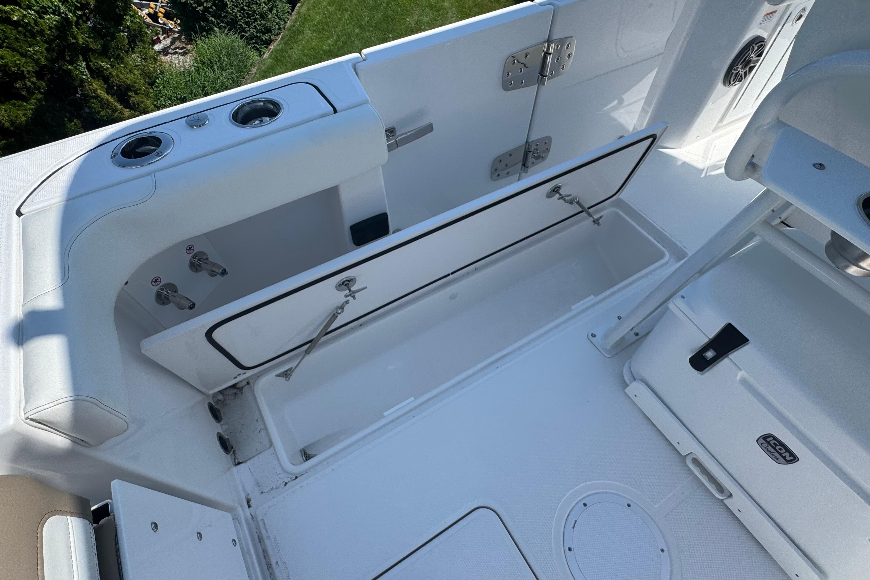 2026 Edgewater 250CC boat interior with open storage compartment and seating area.