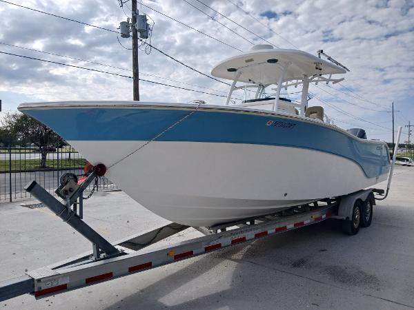 2015 Sea Fox 286 Commander boat on trailer, blue and white hull, parked outdoors.