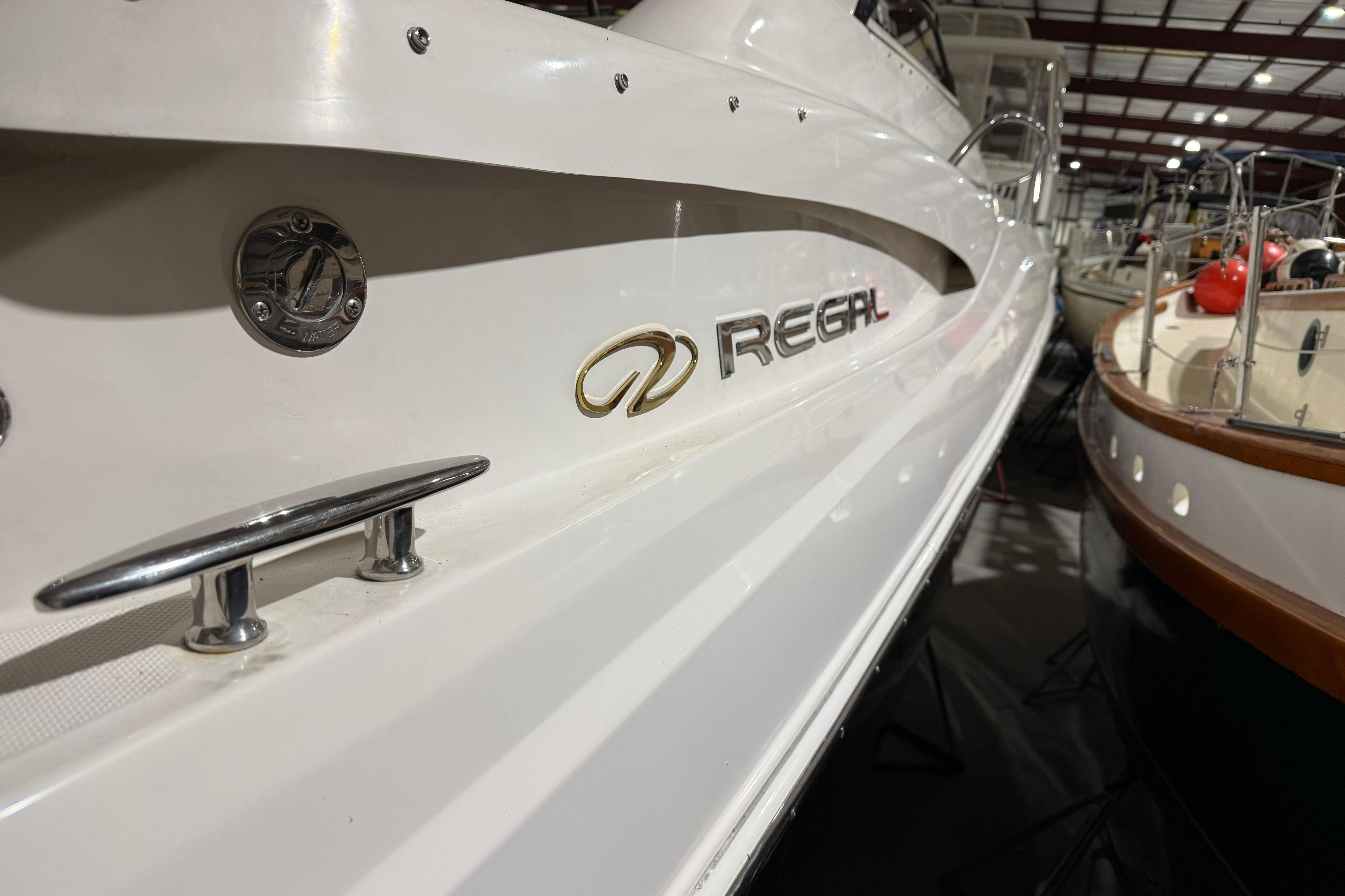 2007 Regal Commodore 3760 IO boat in storage, showcasing sleek design and branding.
