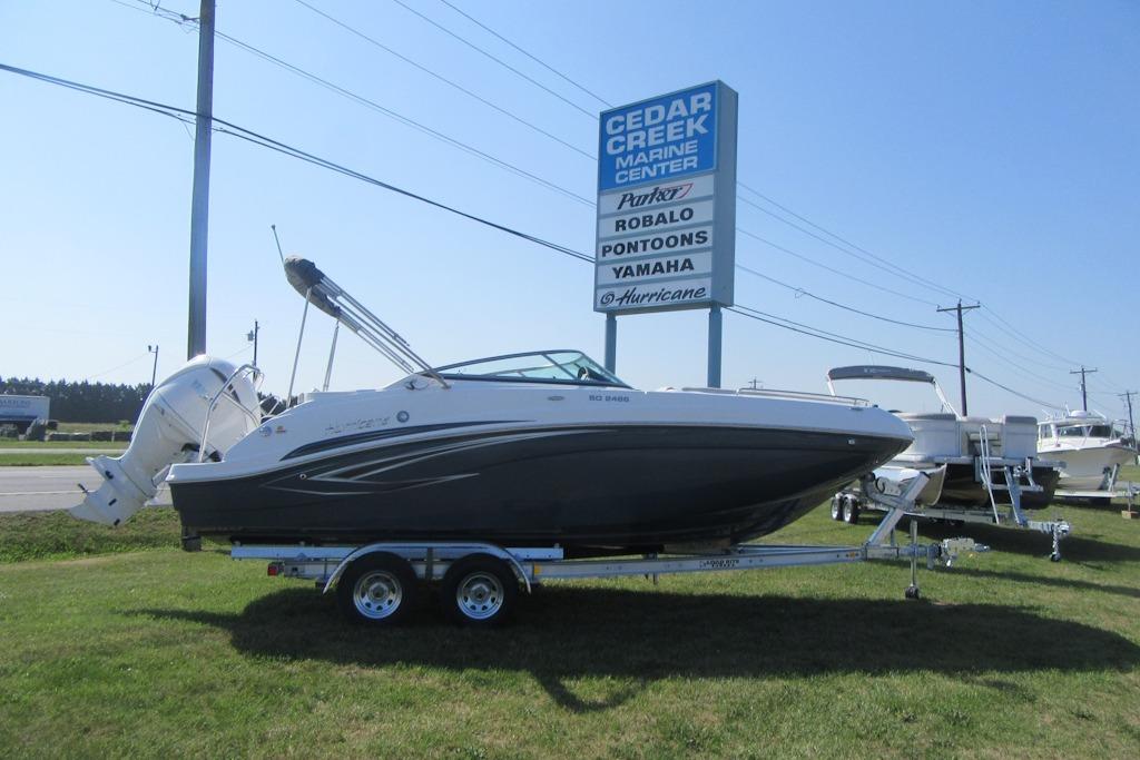 2027 Hurricane SunDeck 2486 OB boat on trailer at Cedar Creek Marine Center.