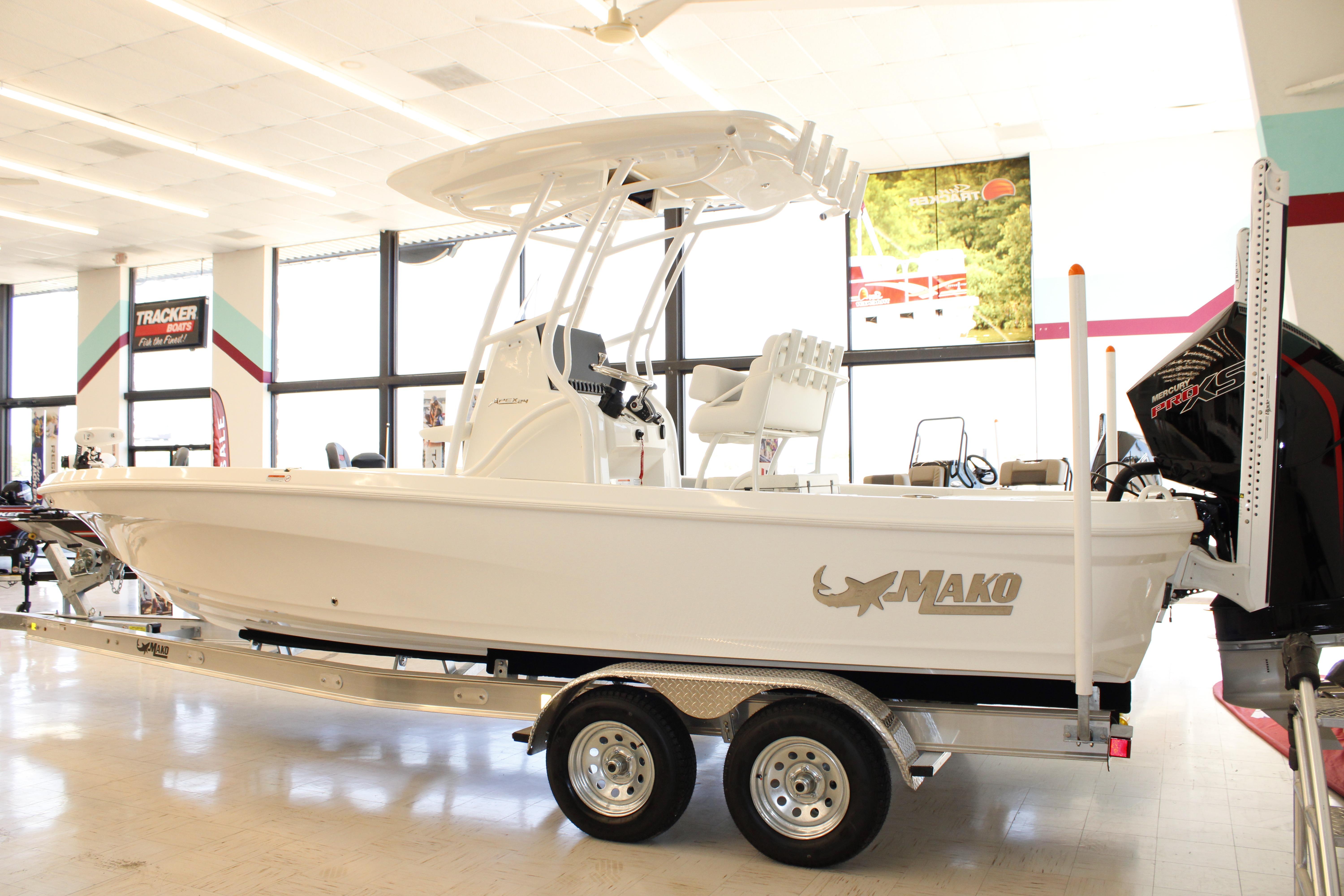 2026 Mako 24 APEX boat displayed indoors on a trailer.