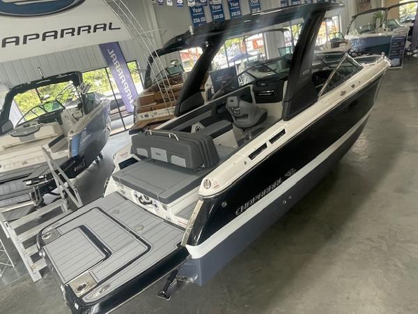 2025 Chaparral 267 SSX boat in showroom, sleek design, luxury seating, modern features.
