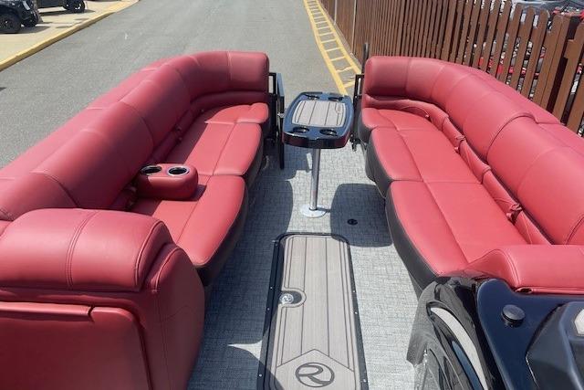 2026 Regency 250 DL pontoon boat with luxurious red seating and central table.