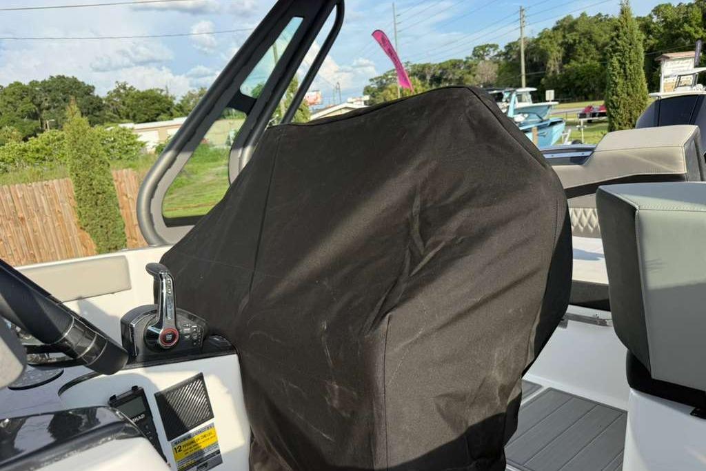 Interior of 2026 Monterey Elite 25 OB boat with covered steering console.