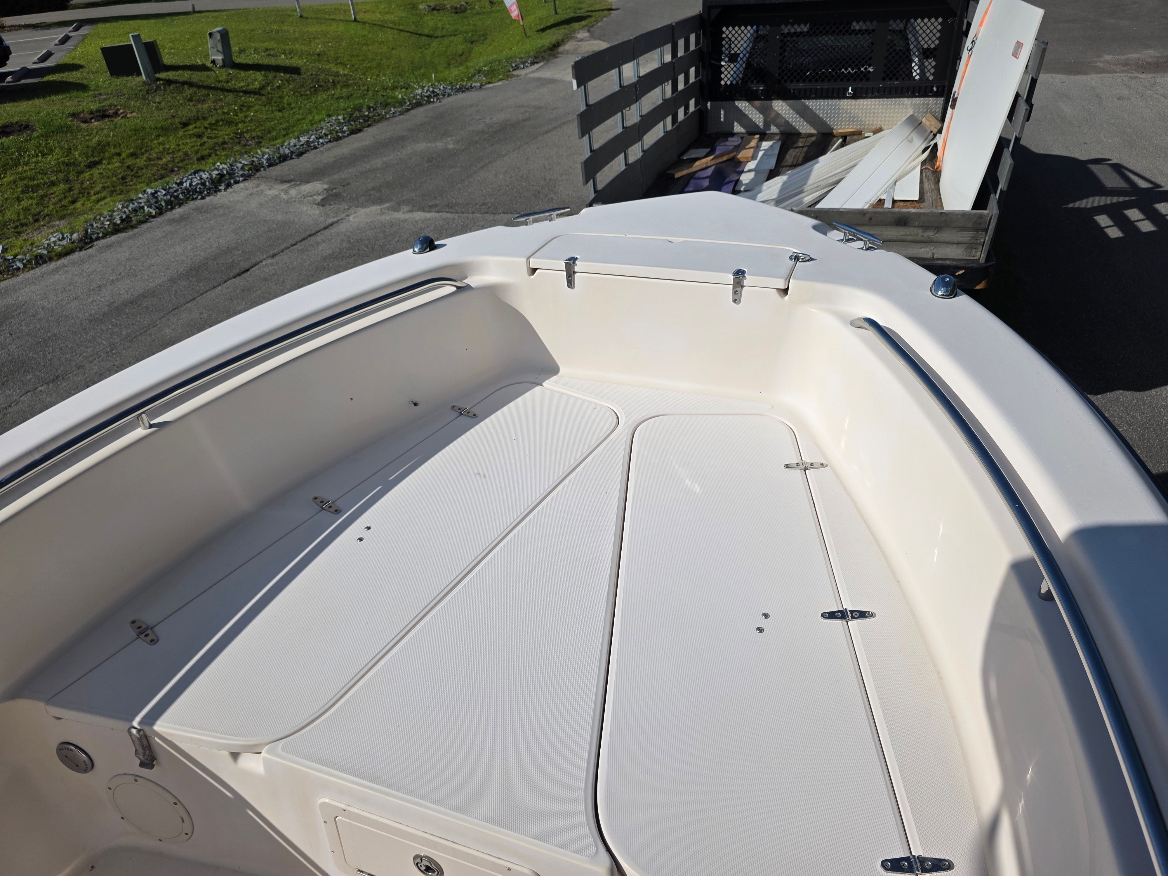 The image shows the bow deck of a 2006 Grady-White 257 boat, featuring storage hatches.