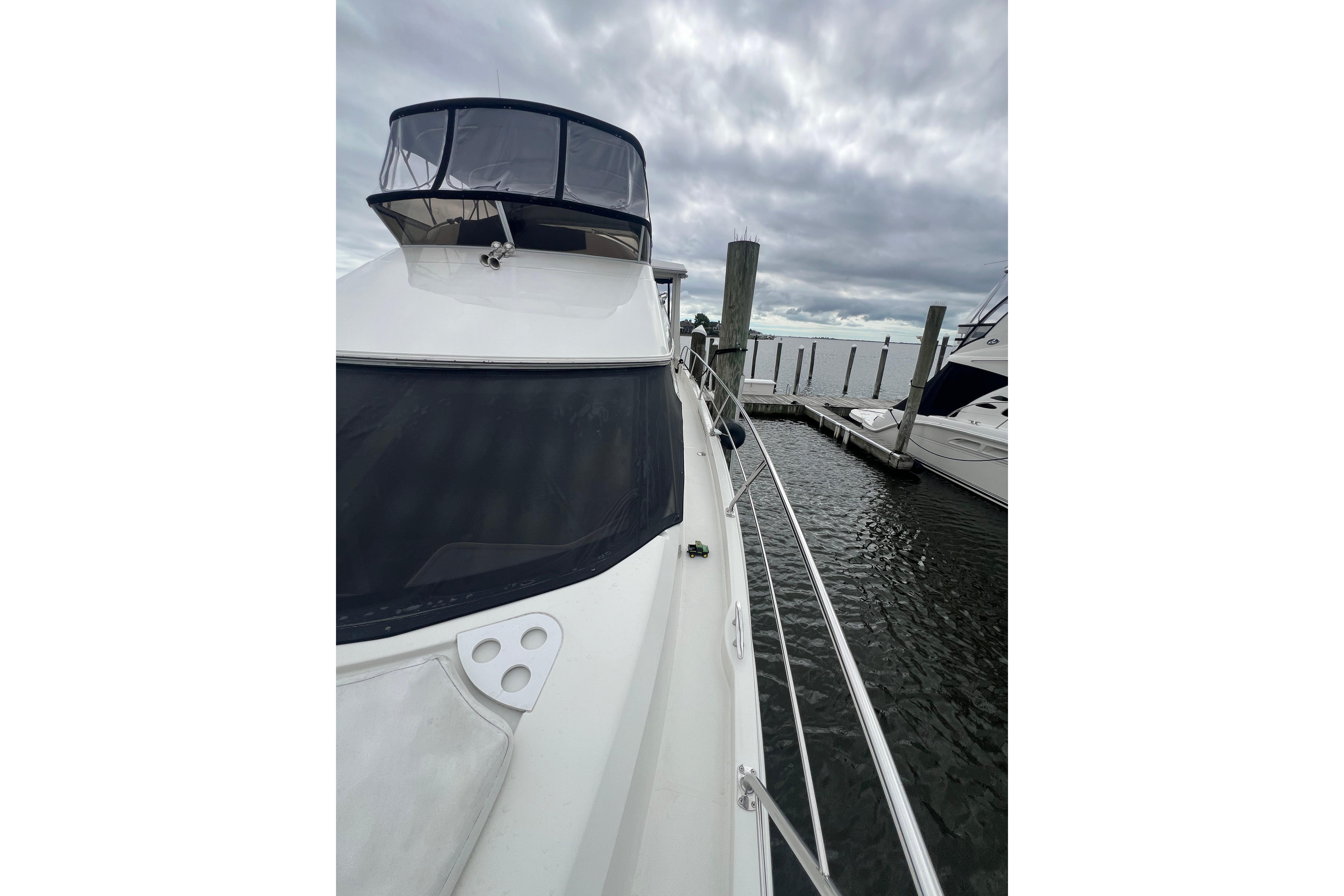 2006 Carver 43 Motor Yacht docked under cloudy skies.