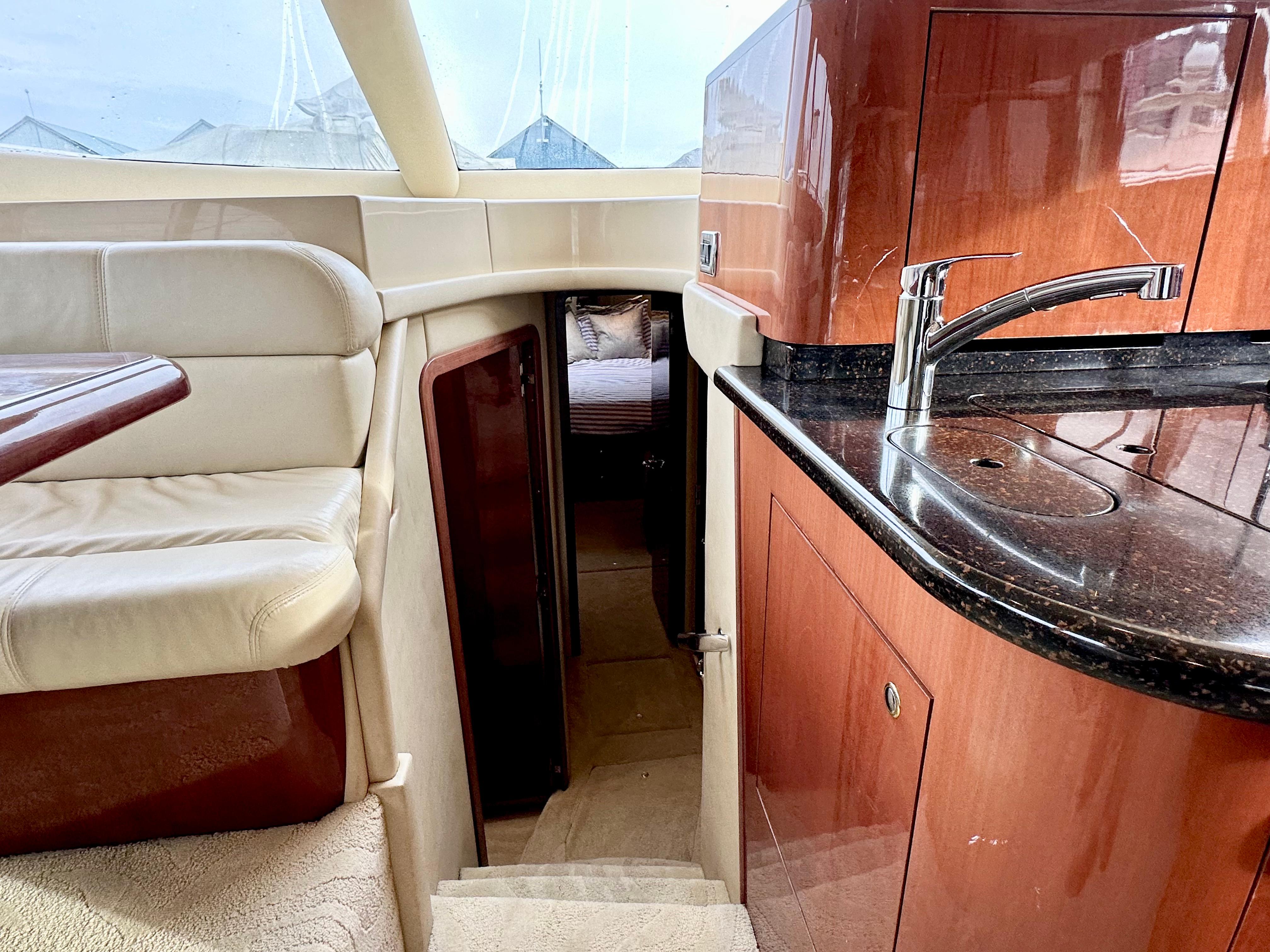 Interior of 2002 Sea Ray 560 Sedan Bridge yacht with luxurious seating and kitchenette.