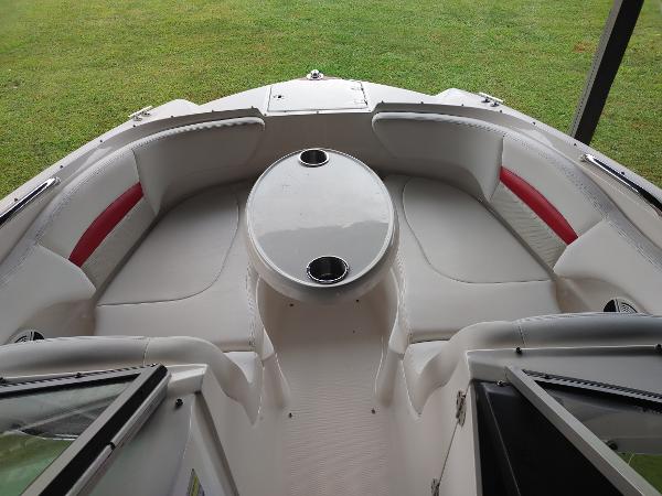 2014 Chaparral 224 Sunesta boat interior with seating and table.