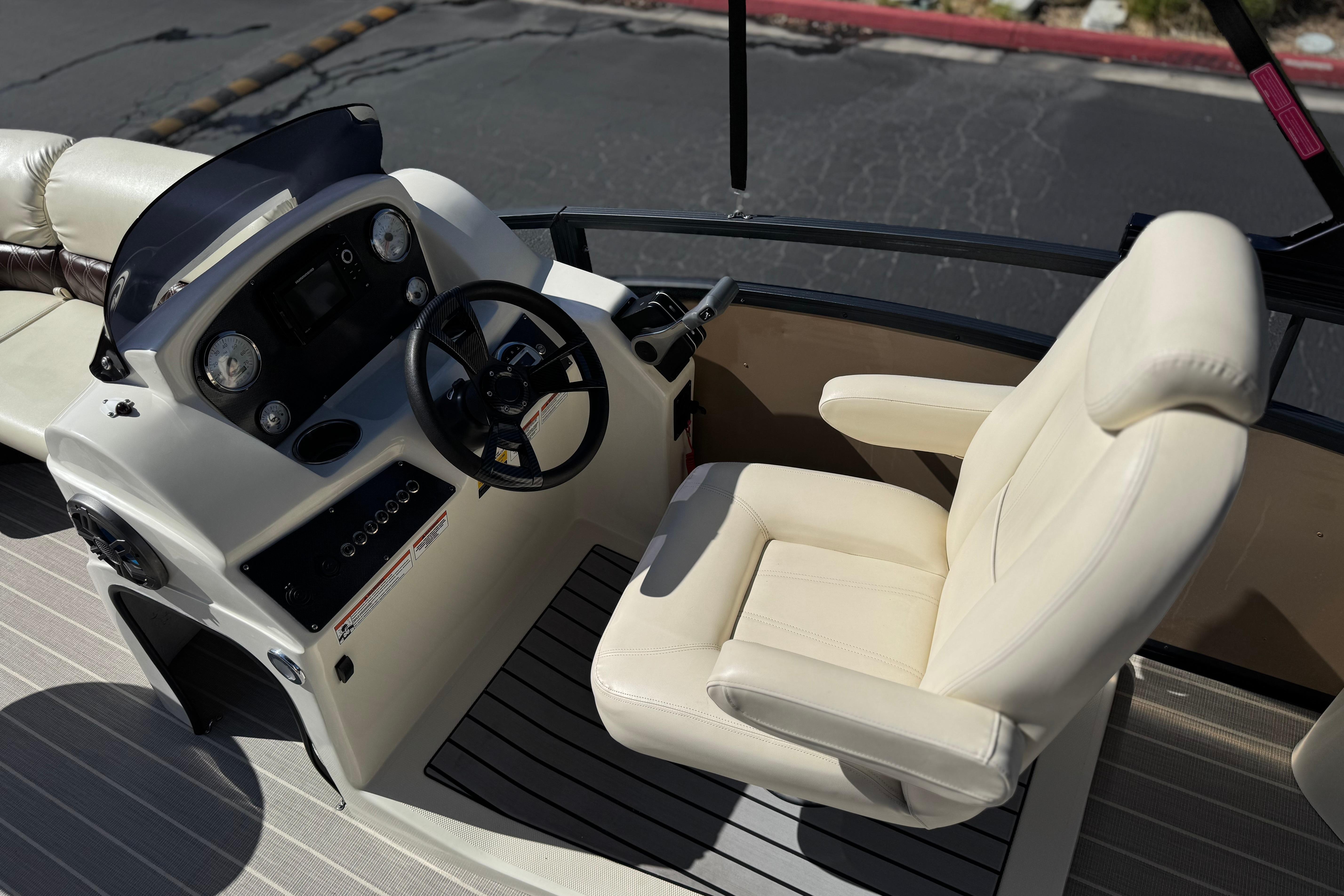 2023 Lexington 623 ST Xtreme boat cockpit with steering wheel and plush captain's chair.