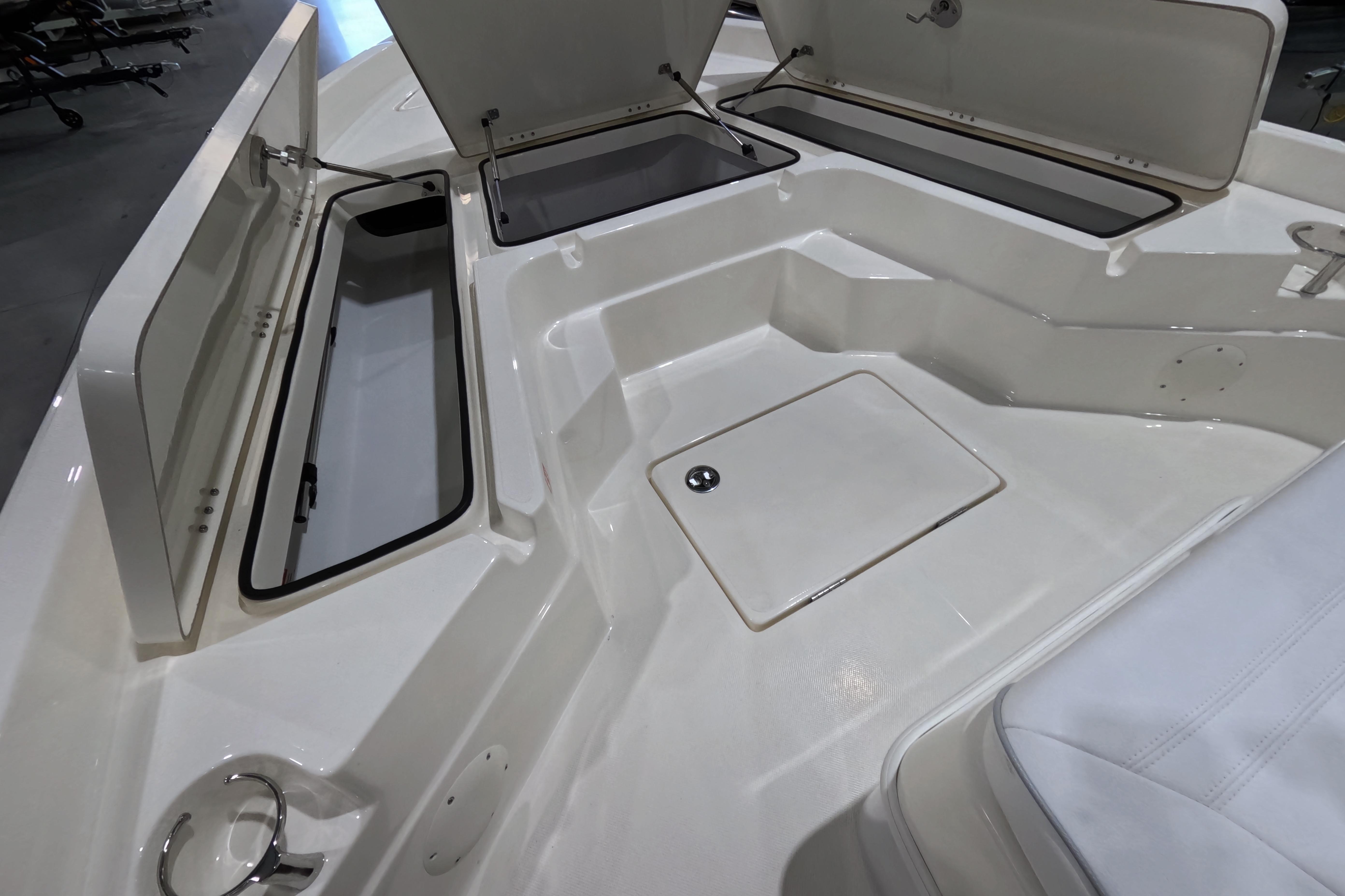 2026 Skeeter SX230 boat interior with open storage compartments and seating area.