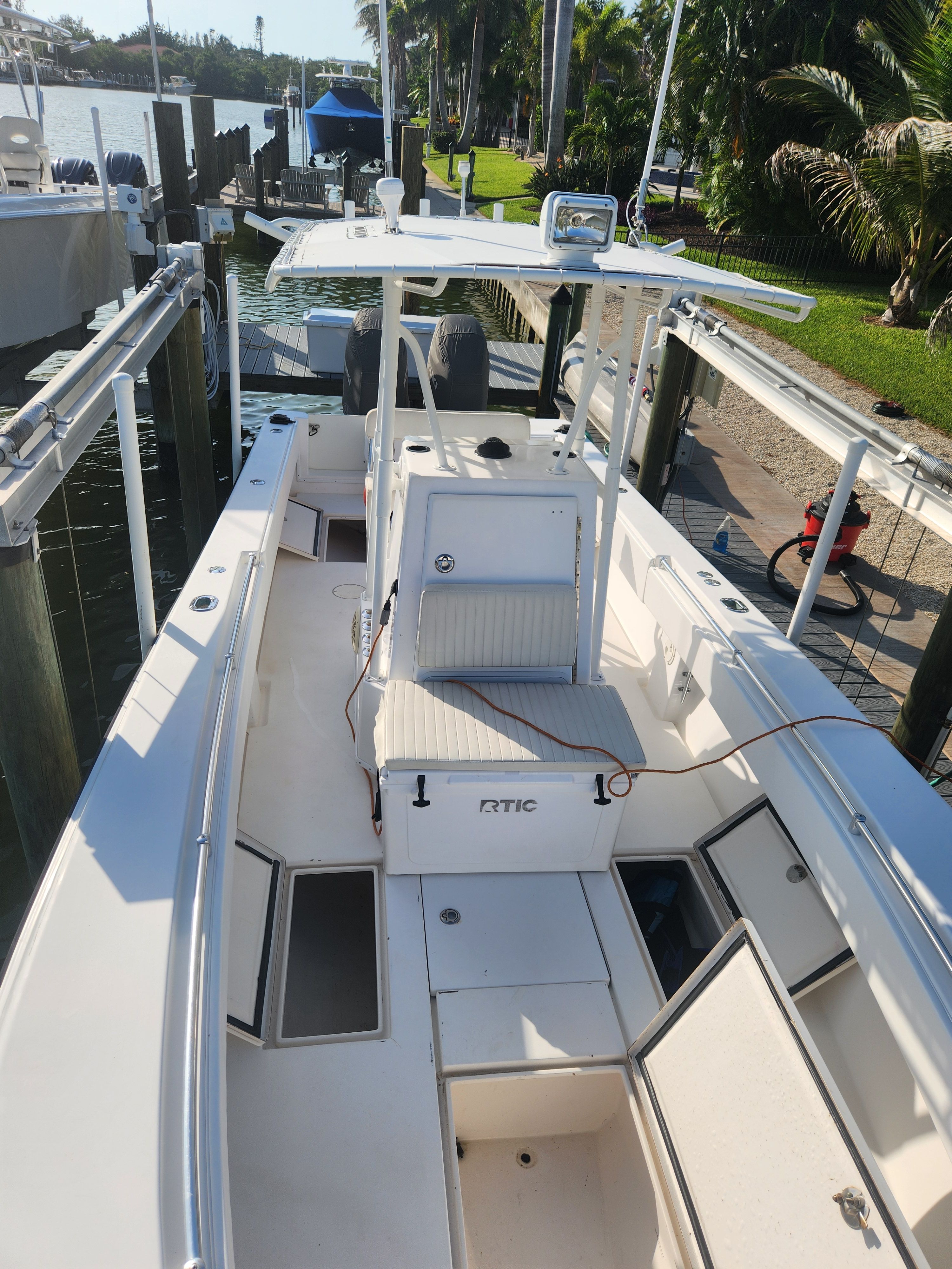 2005 Contender 27T at a dock with open storage and seating area.