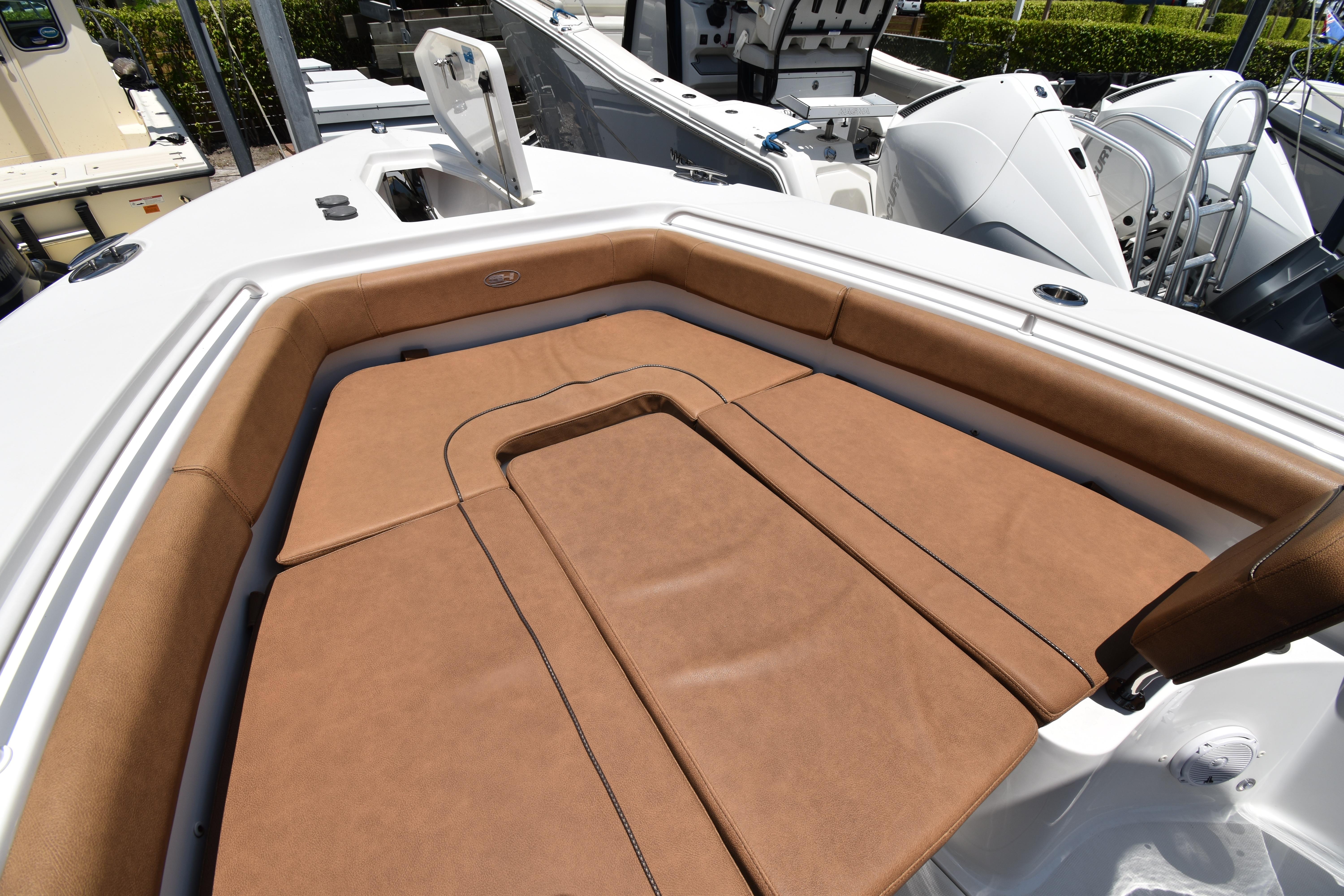 Luxurious seating area on a 2020 Sea Hunt Ultra 275 SE boat, featuring brown upholstery.