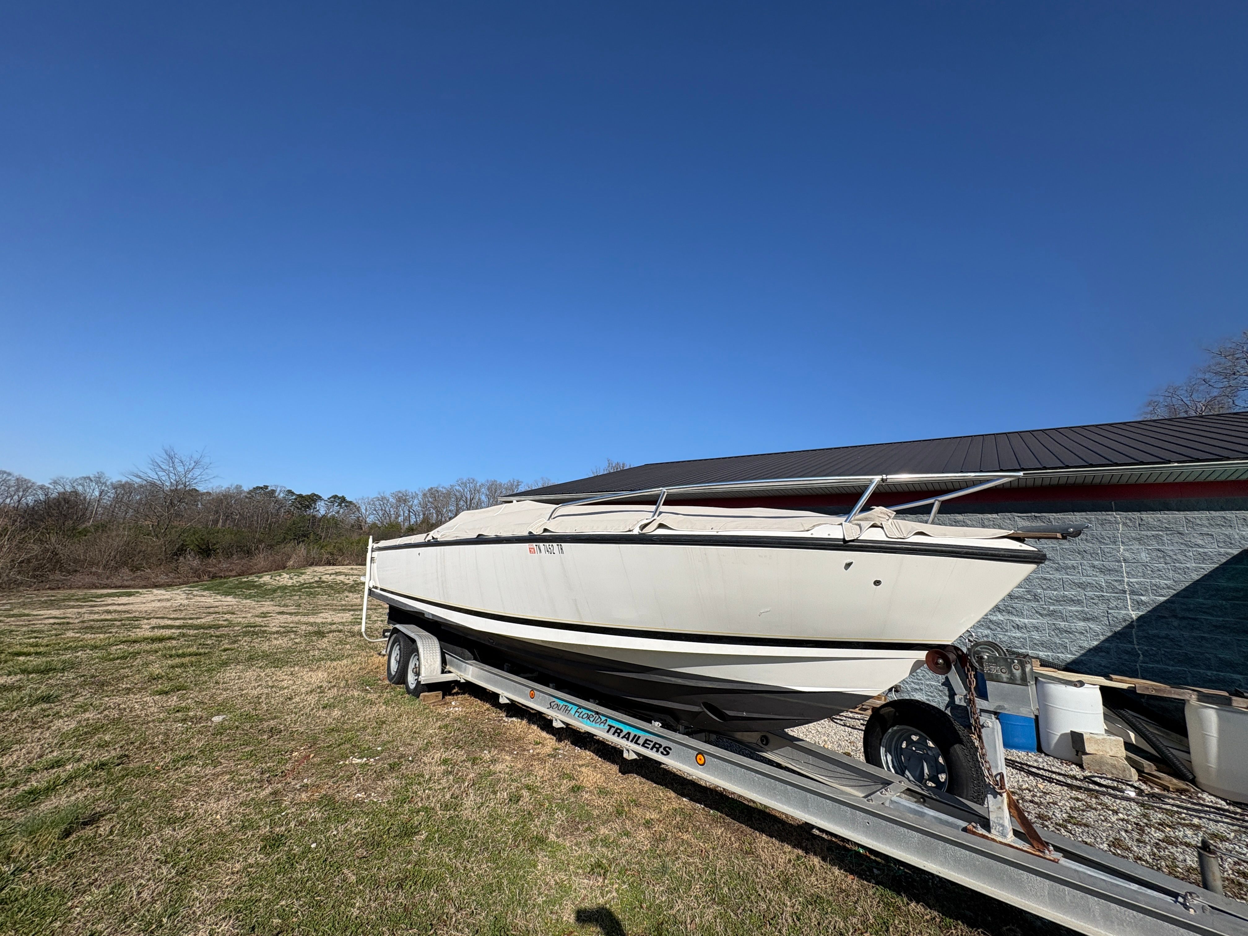 Intrepid 322 Cuddy Center Console boat on trailer, year 2002.