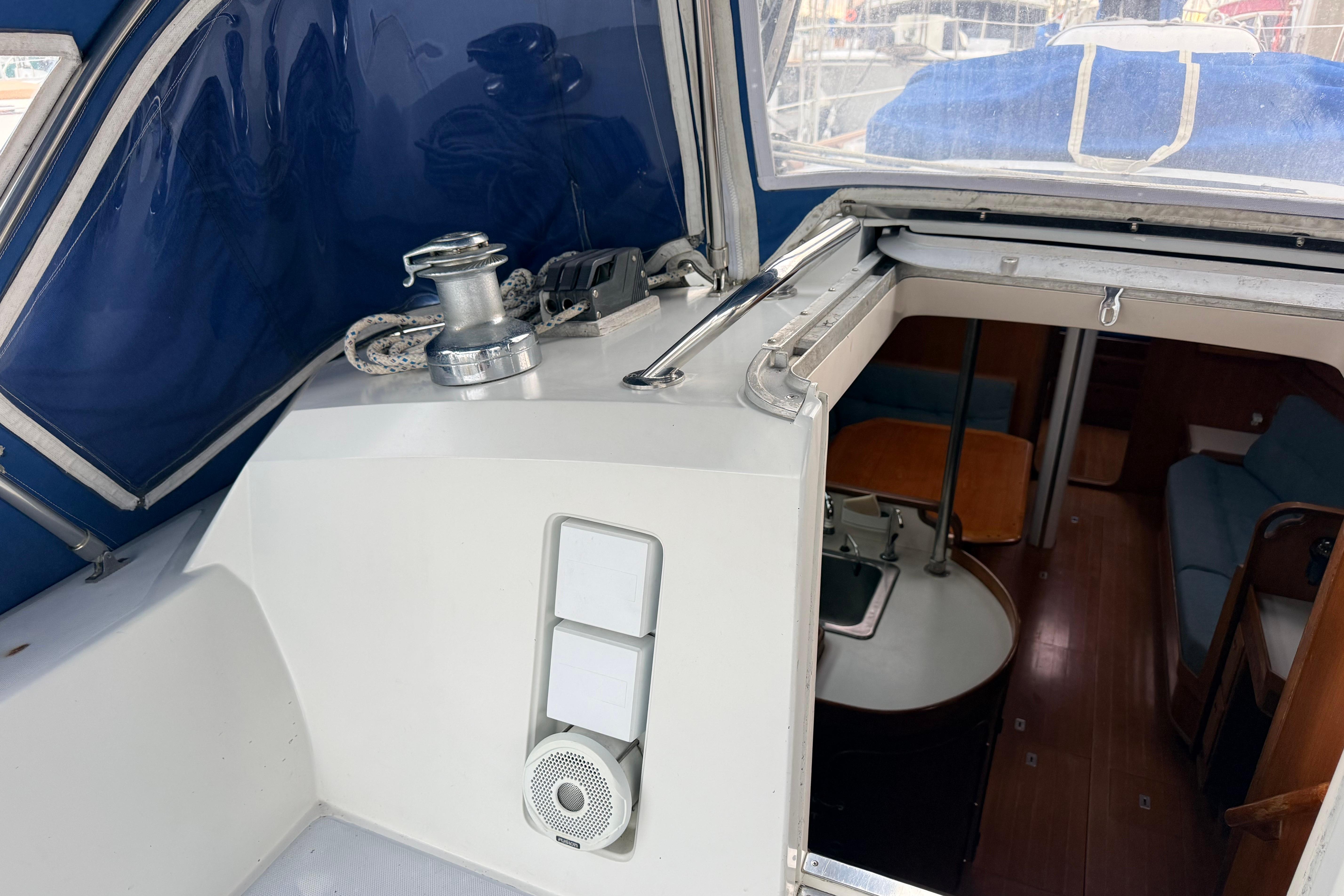 Interior view of 1987 Norseman 400 sailboat with blue canopy and cabin entrance.