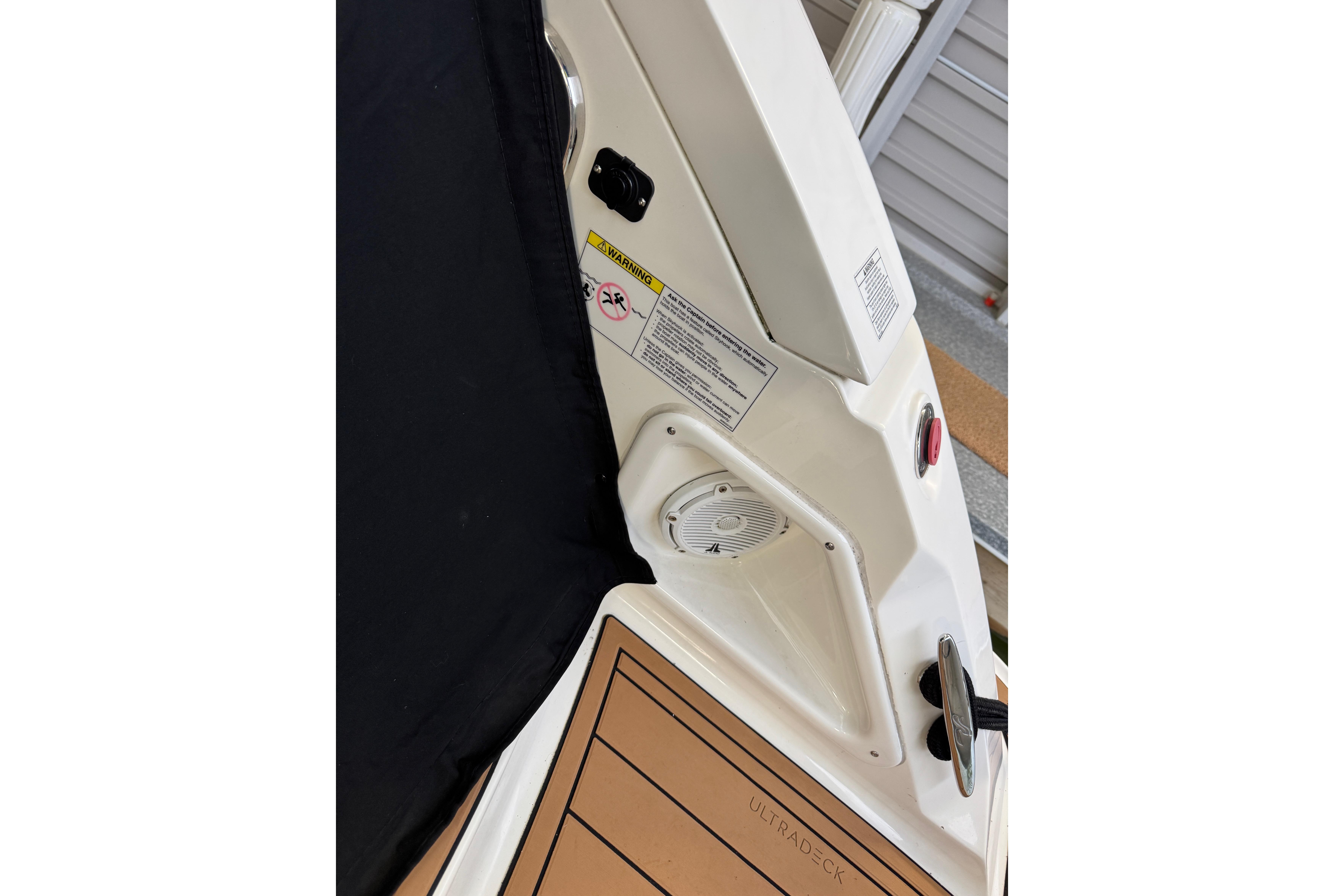 Sea Ray 370 Sundancer 2011 boat interior with speaker and warning label.