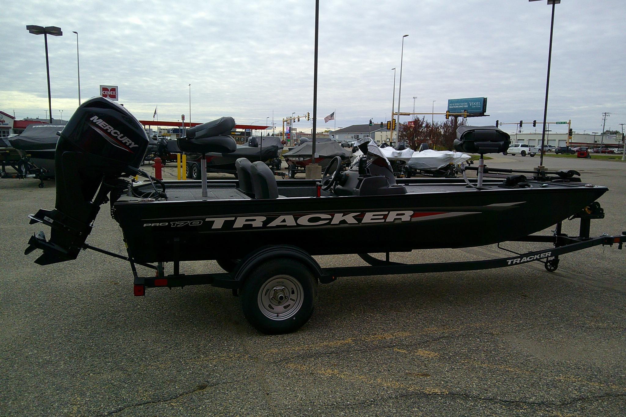 2025 Tracker Pro 170 boat with Mercury engine on trailer in parking lot.