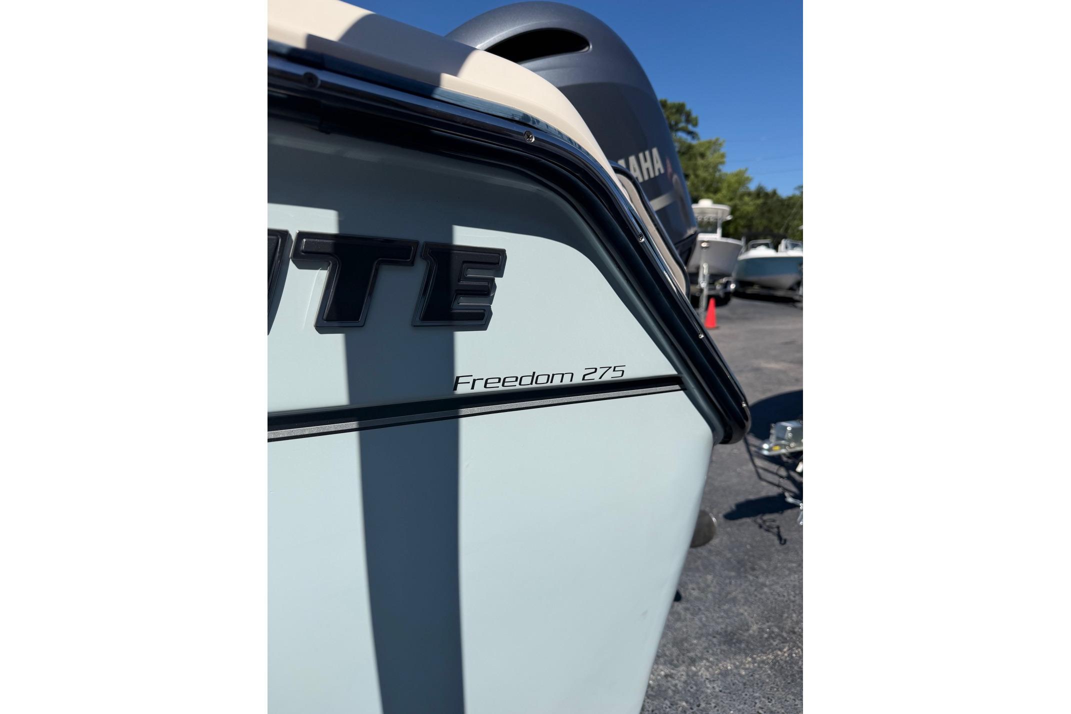 2022 Grady-White Freedom 275 boat, close-up view of model name on hull.