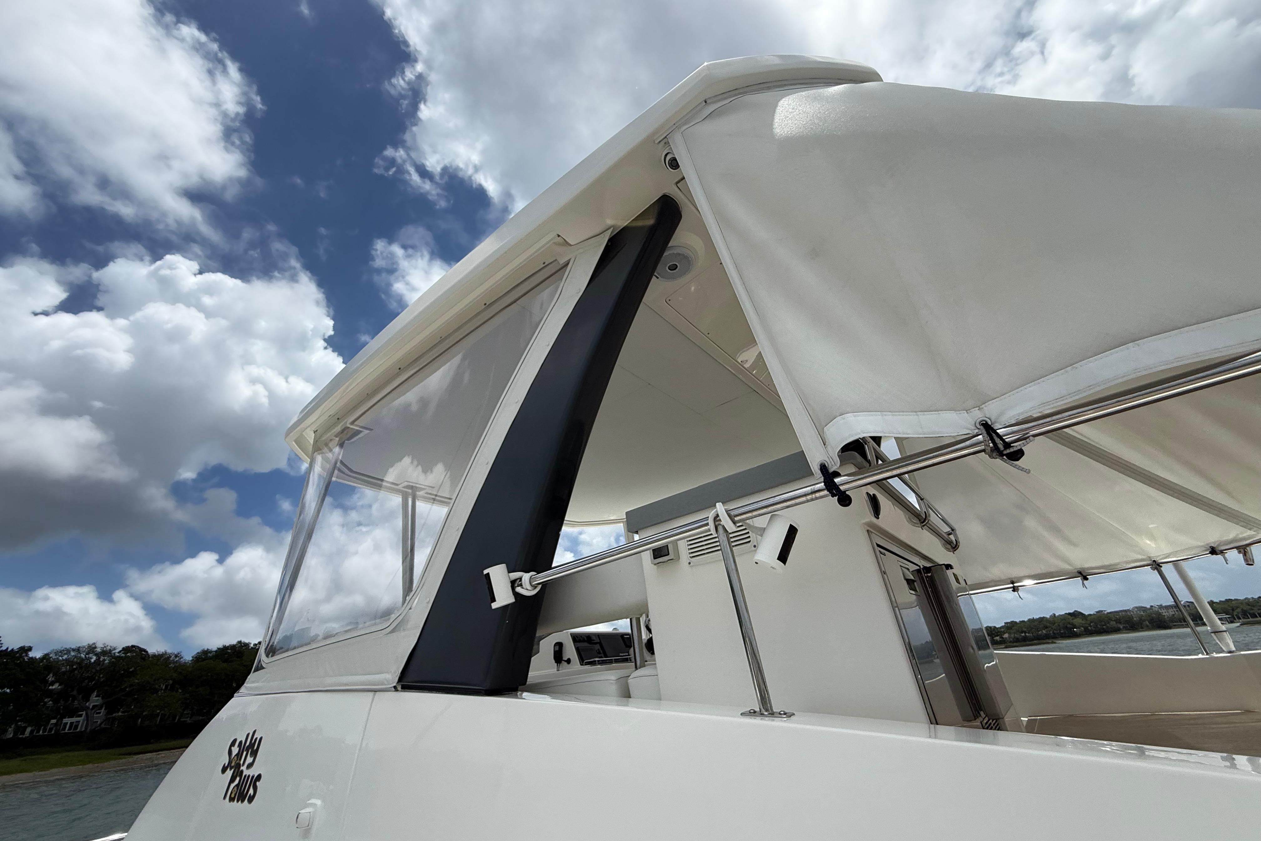 2021 Leopard 43 Powercat with white canopy under a partly cloudy sky.