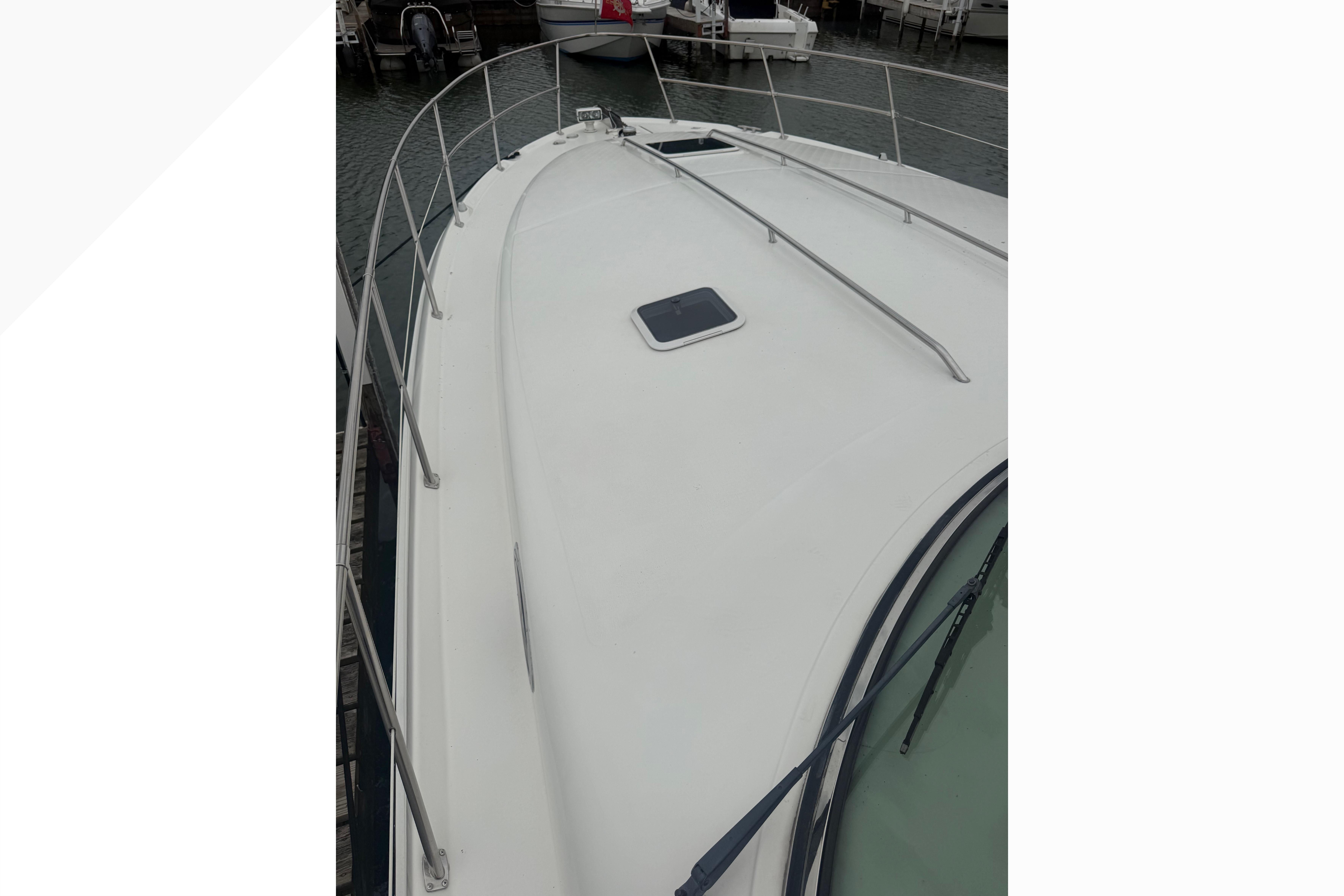 1998 Sea Ray Sundancer 400 yacht deck with railing, docked at marina.