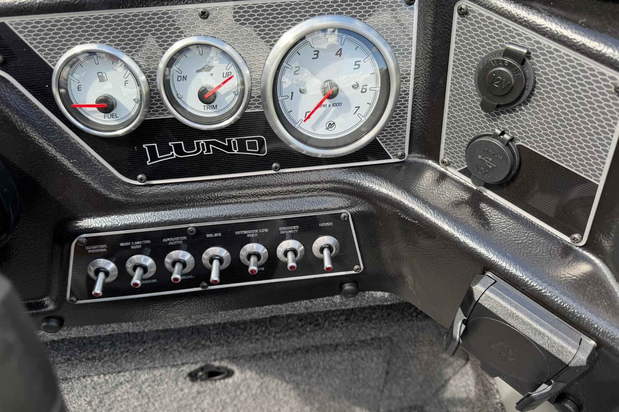 Dashboard of 2027 Lund 1875 Crossover XS boat with gauges and switches.