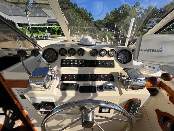 The cockpit of a 1985 Viking 35 Express with controls and a Garmin device.